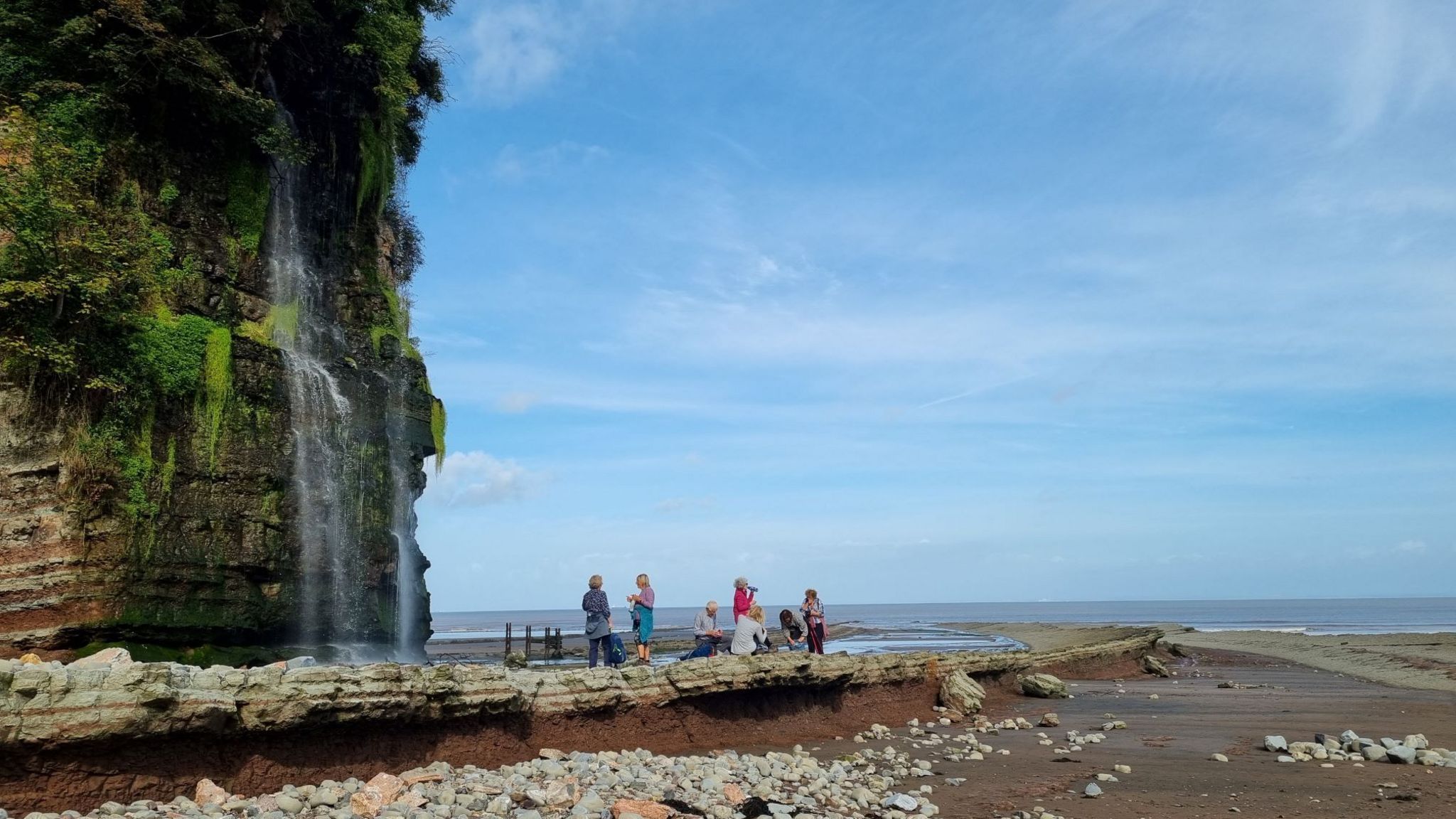 Walkers take a break by the St Audries Waterfall during the 2023 Somerset and Exmoor Coastal Festival 