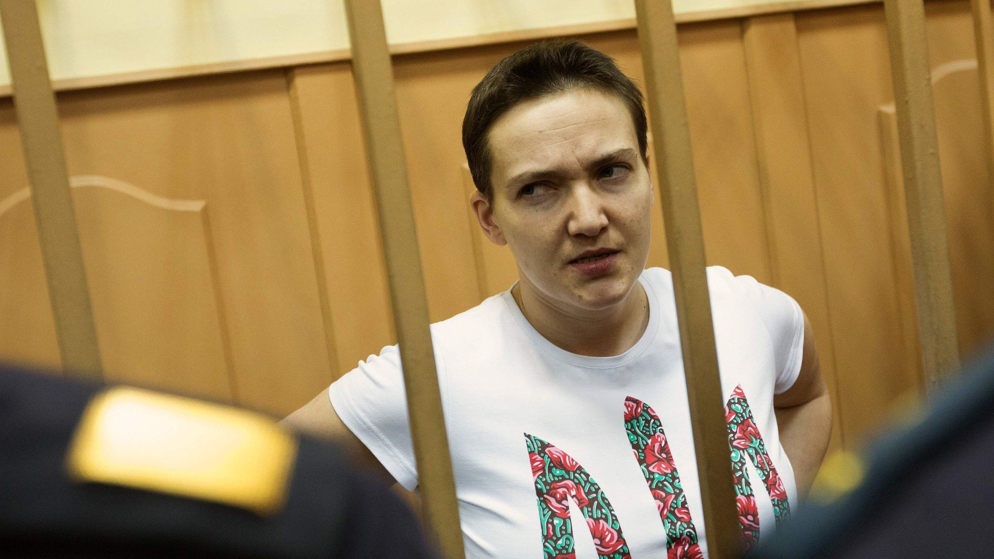 This file photo taken on November 7, 2014 shows Nadiya Savchenko standing inside the defendant"s cage during his hearing in the Basmanny district court in Moscow. illegally.