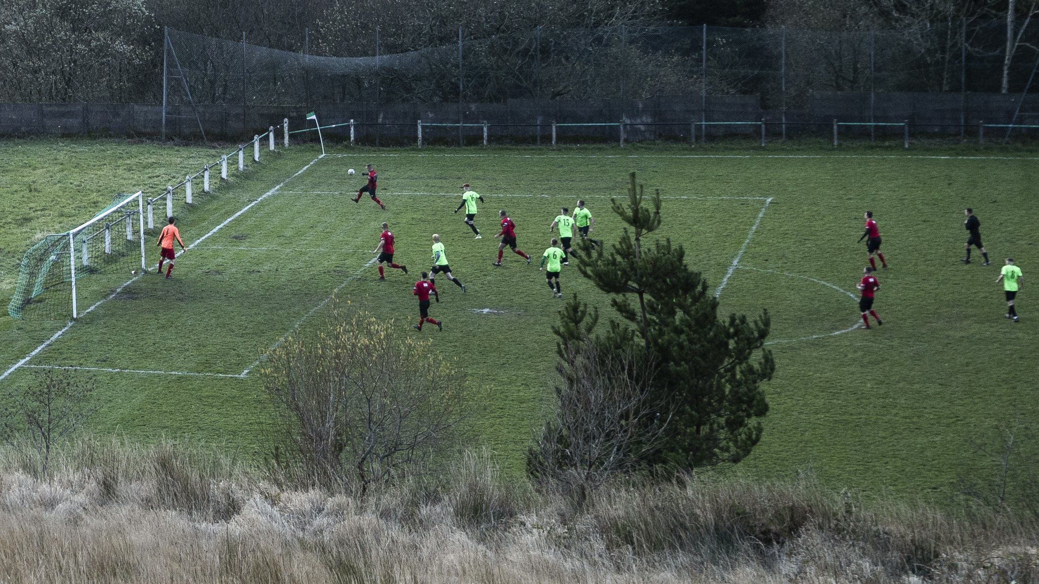 Action from a grassroots football match in Wales