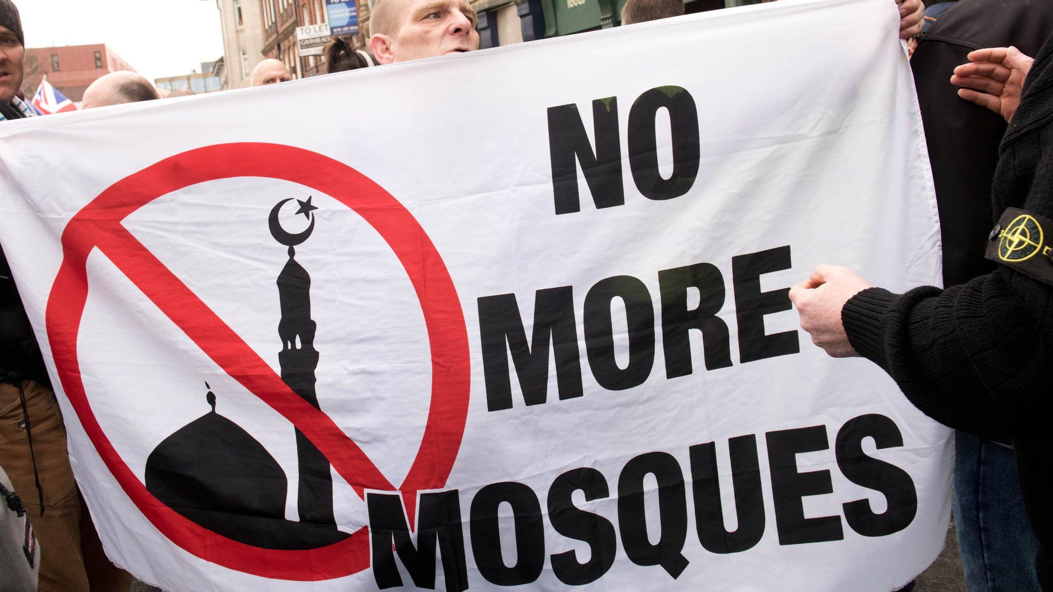 Protesters hold a banner reading No More Mosques during a demonstration by the UK branch of the German group Pegida