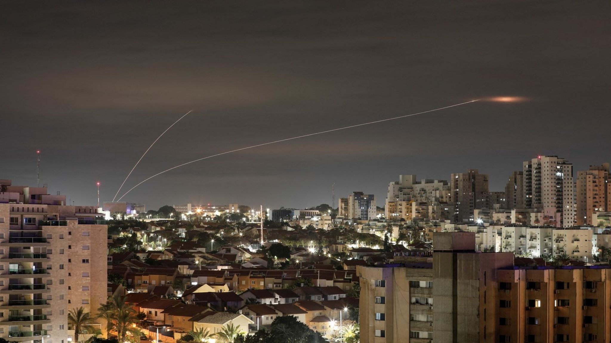 A trail of smoke is seen as rockets from Gaza are intercepted in the early morning, as seen from Ashkelon, Israel (23 February 2023)