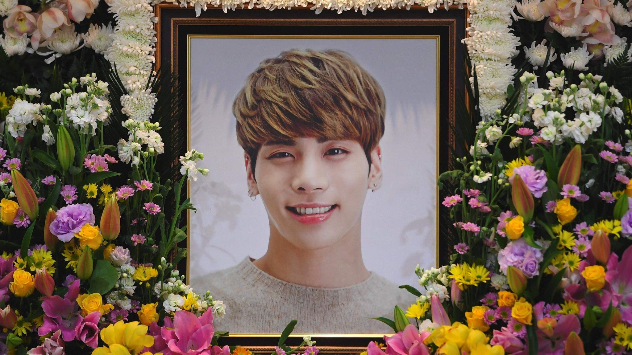 The portrait of Kim Jong-Hyun, a 27-year-old lead singer of the massively popular K-pop boyband SHINee, is seen on a mourning altar at a hospital in Seoul on 19 December 2017.
