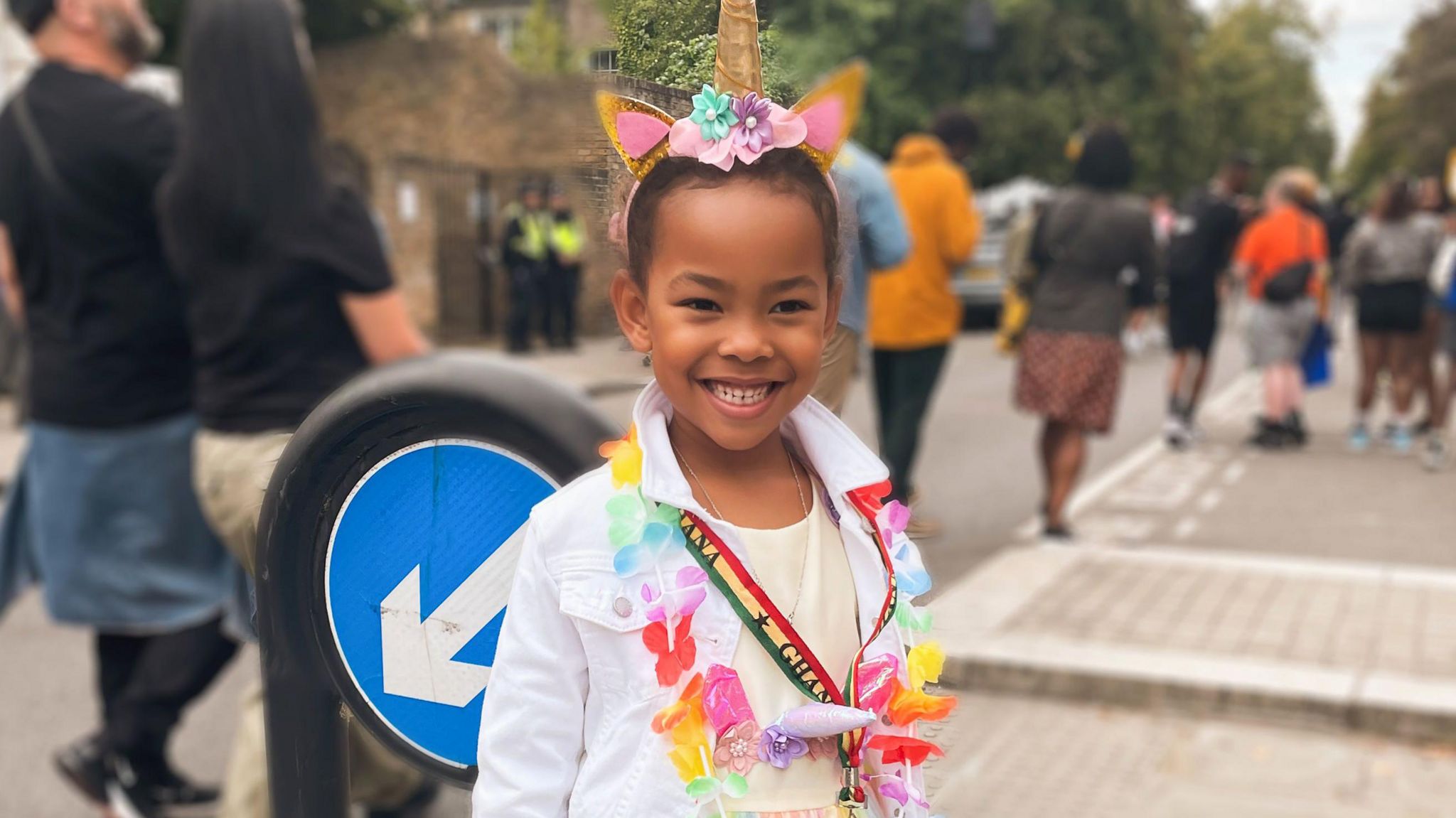 Isabella wearing a tutu, unicorn headdress and flower garland at a previous carnival