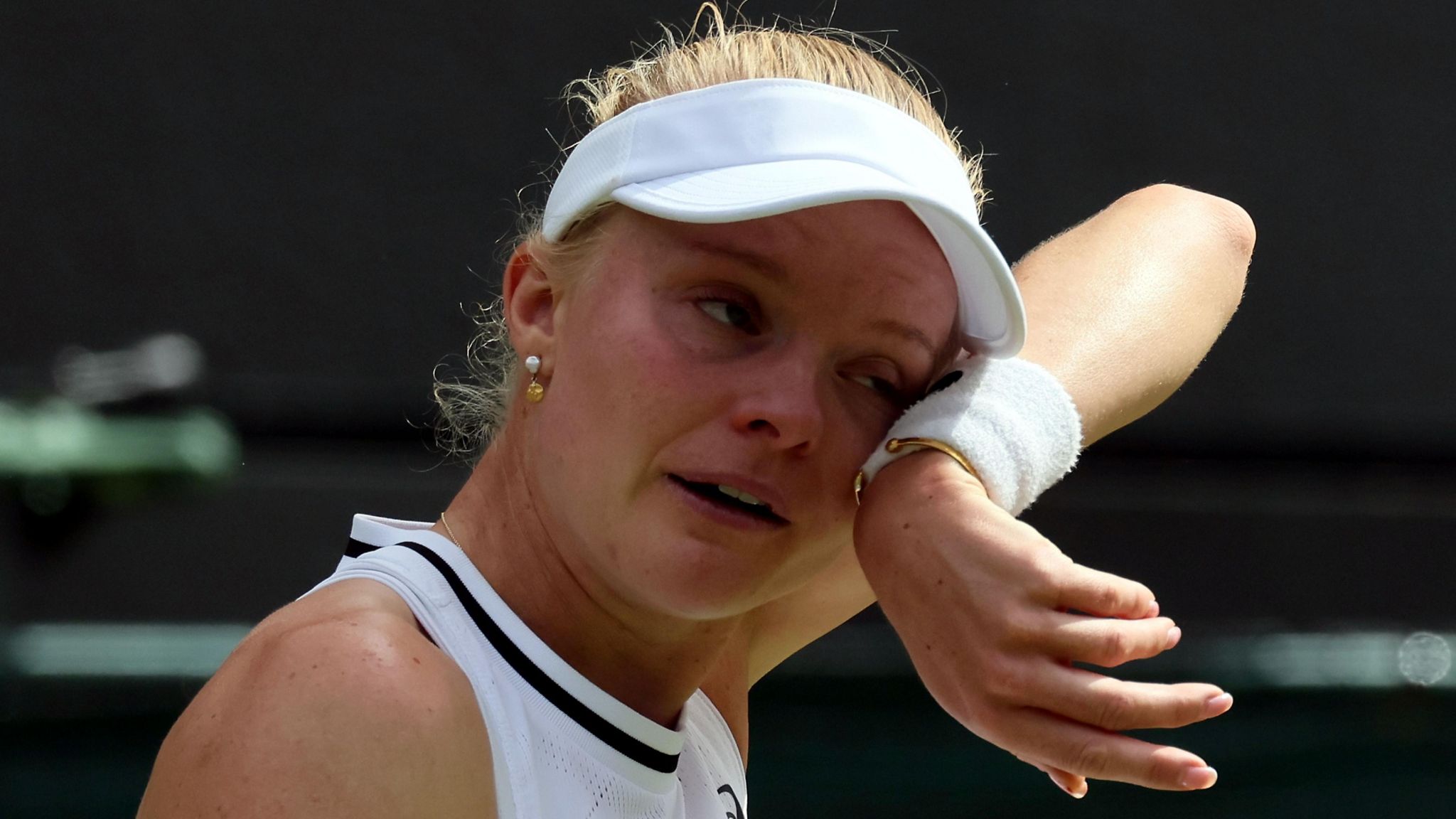 Harriet Dart wipes away tears with her sweatband during her Wimbledon second-round match against Katie Boulter