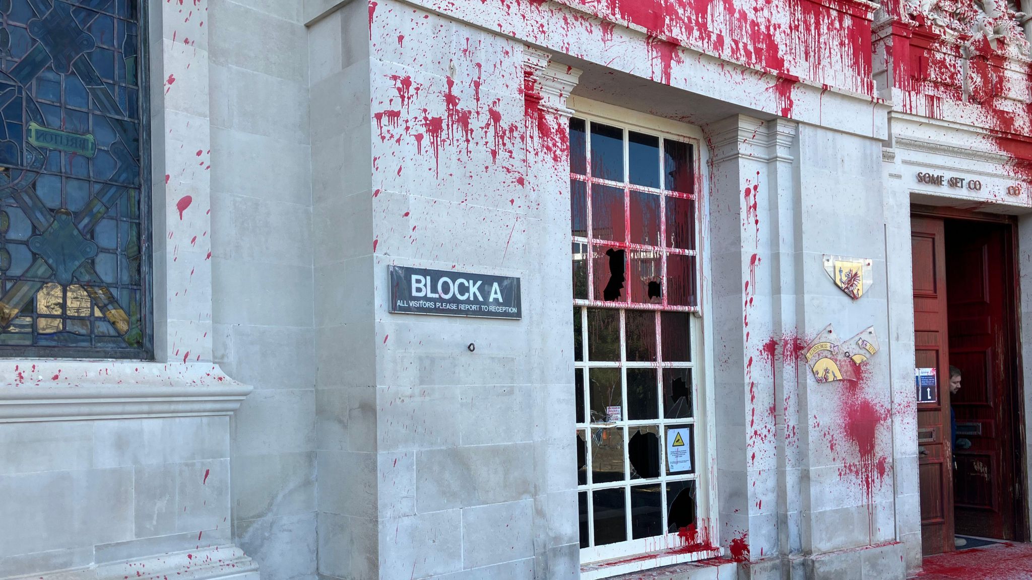 Smashed windows and red paint on the front of Somerset's County Hall