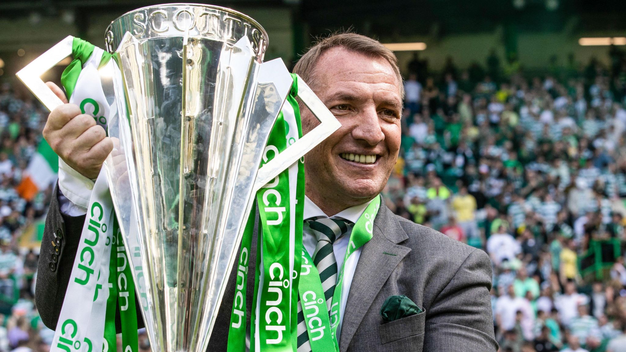 Brendan Rodgers poses for a photo with a trophy