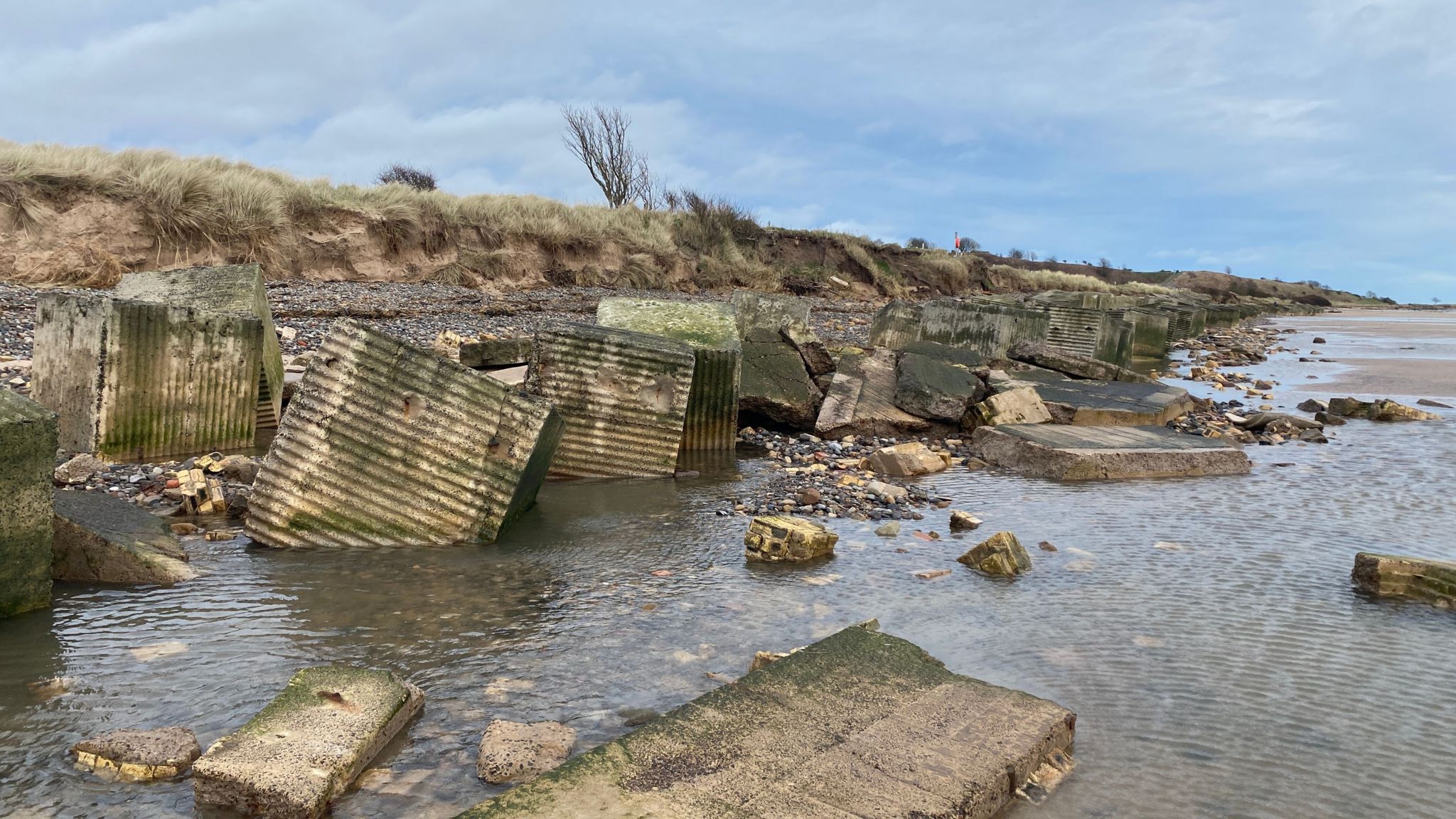 Tank traps and rubble on a beach in Northumberland 