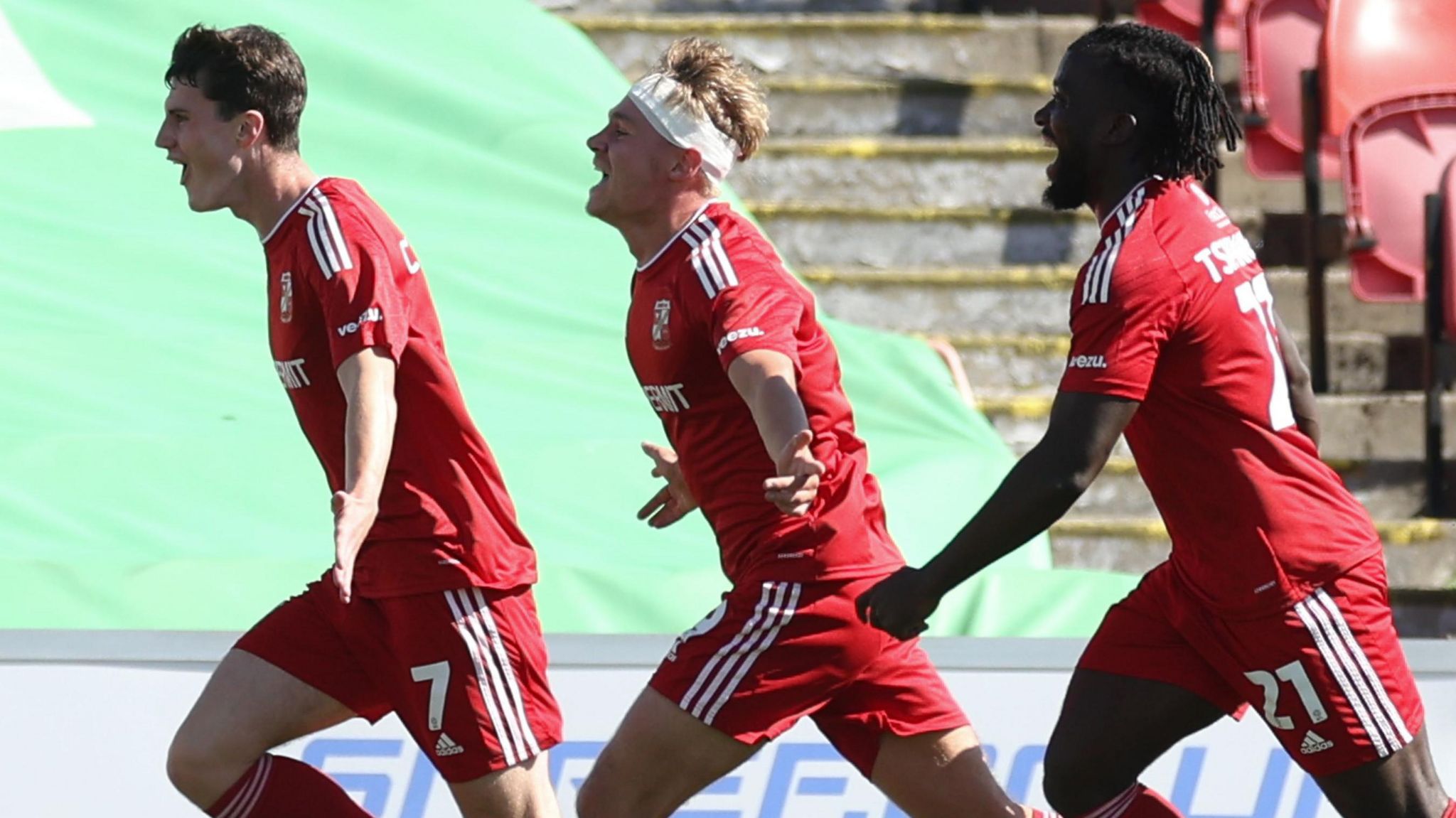 Joel Cotterill, Paul Glatzel and Kabongo Tshimanga of Swindon Town celebrate