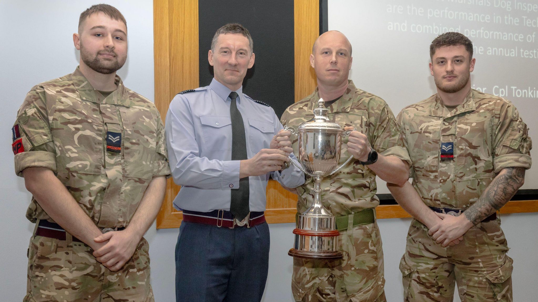 Dog handlers receiving their trophy