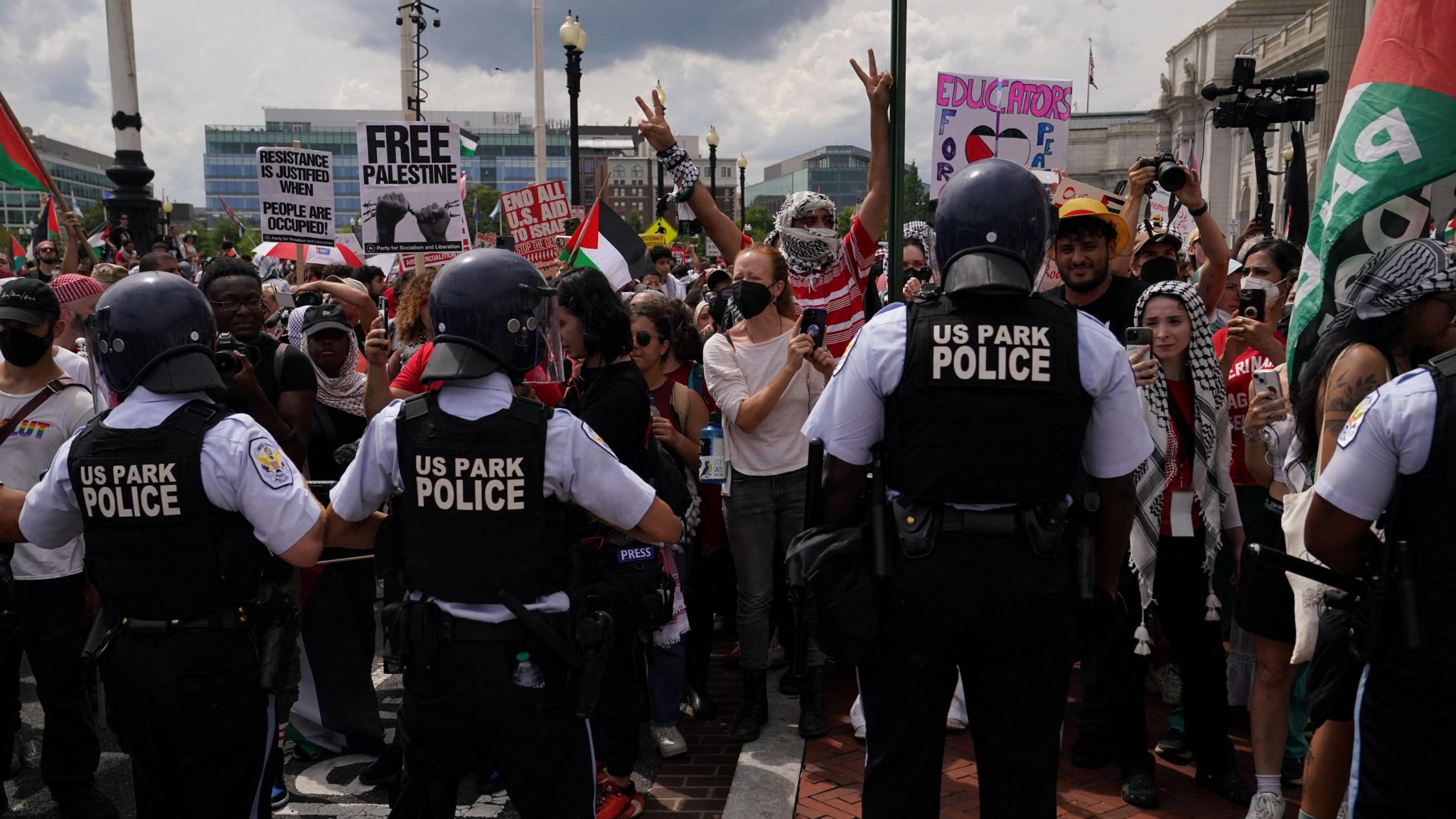 Police officers stand guard as pro-Palestinian demonstrators protest on the day of Israeli Prime Minister Benjamin Netanyahu's address