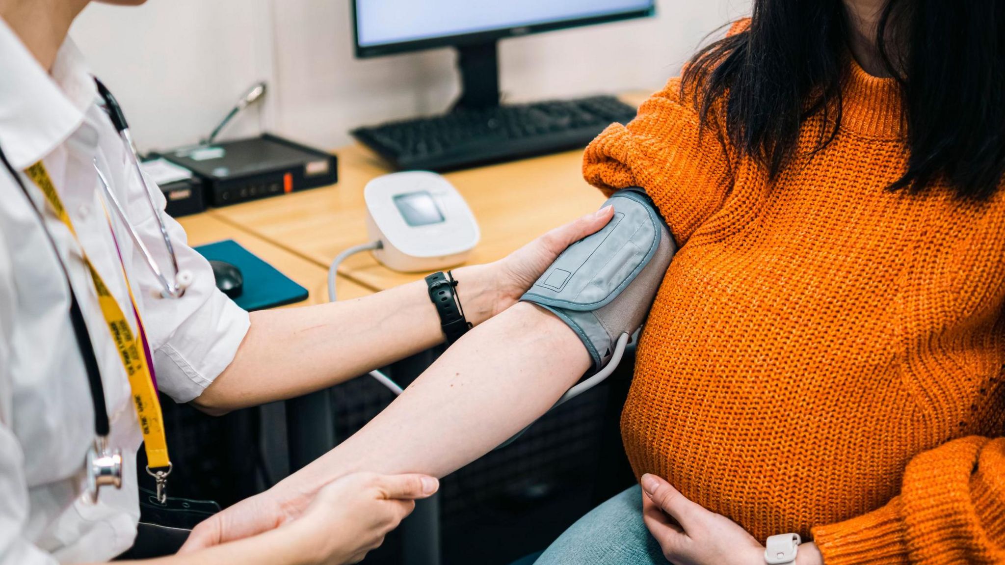 Picture of doctor taking a woman's blood pressure