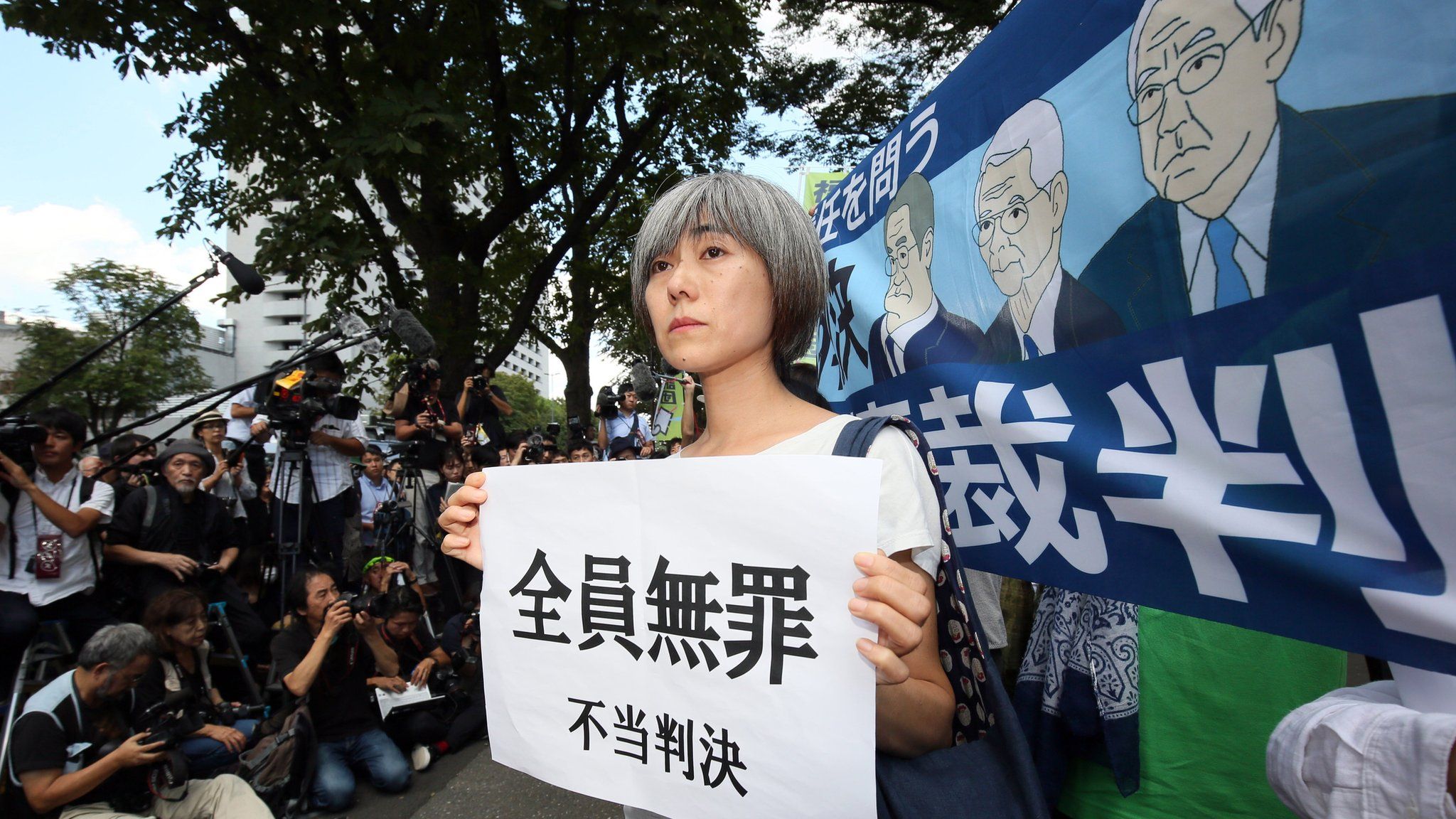 An activist protests outside the Tokyo District Court in Tokyo, Japan, 19 September 2019