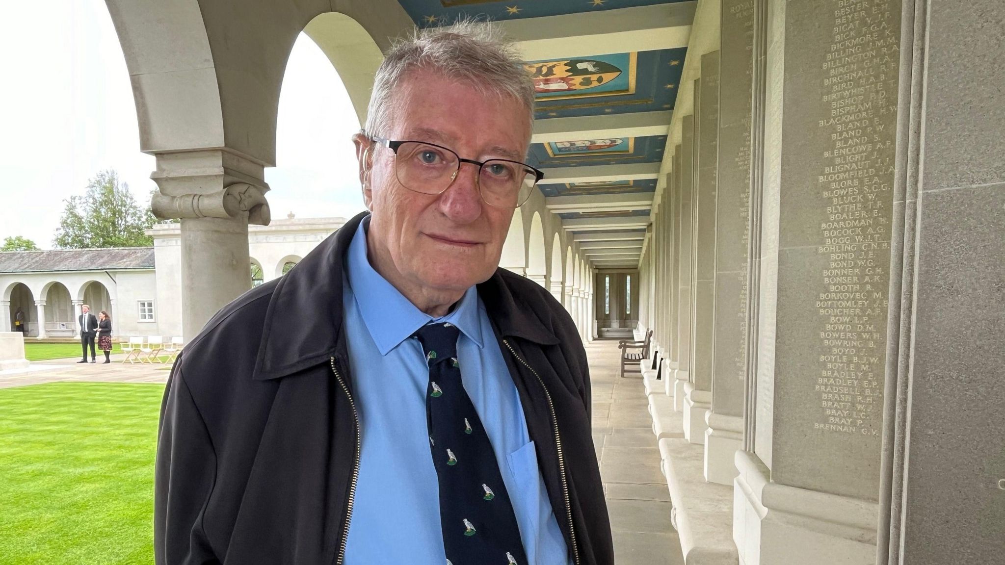 Peter Clare wearing a blue shirt and black tie at the Runnymede Air Forces Memorial