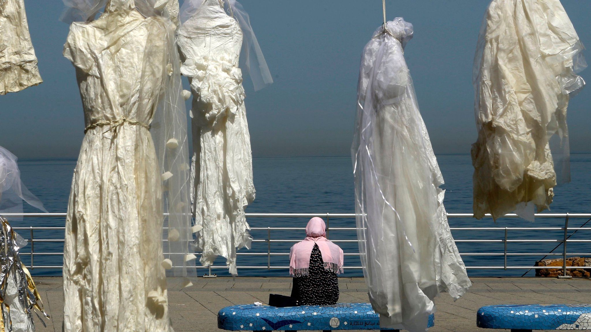 wedding dresses hang in Beirut seafront