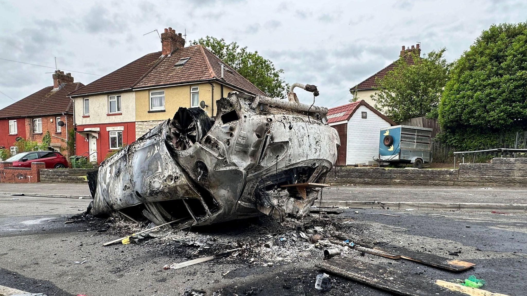 A burnt out car the day after the riot in Ely, Cardiff