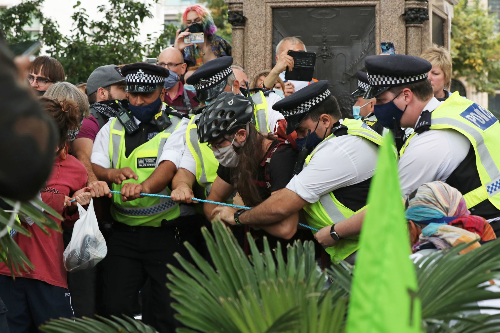 Extinction Rebellion protesters tussle with police officer in Parliament Square, London