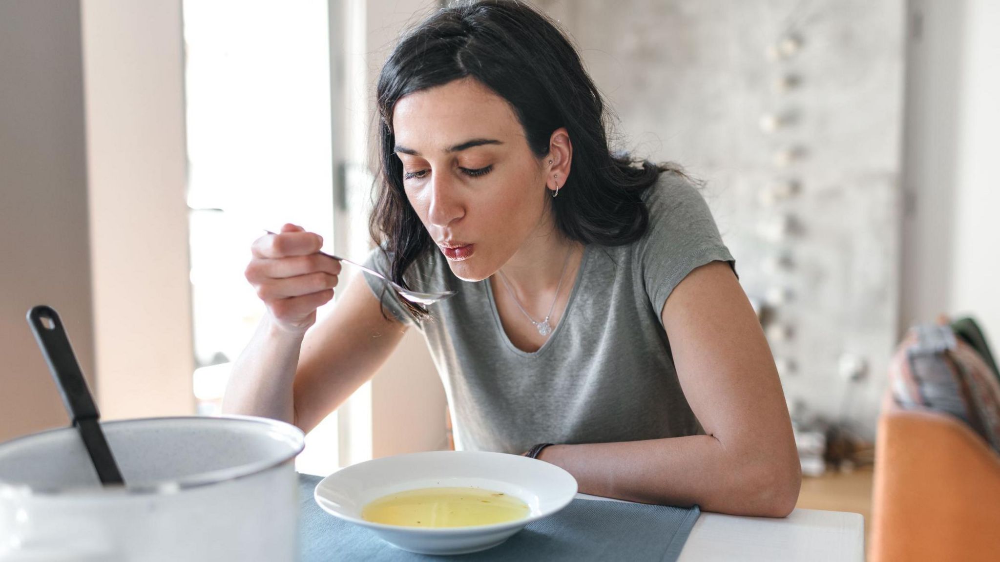 Woman eating soup