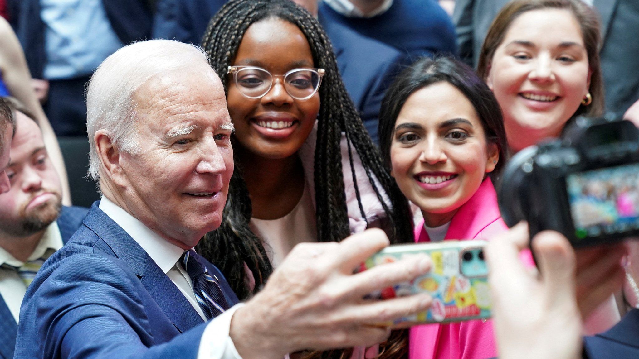 Joe Biden takes a selfie with young people at Ulster University