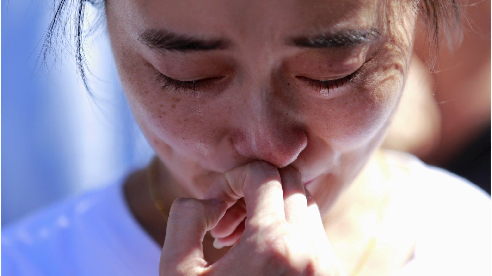 A family member of a passenger onboard the missing Malaysia Airlines Flight MH370, cries