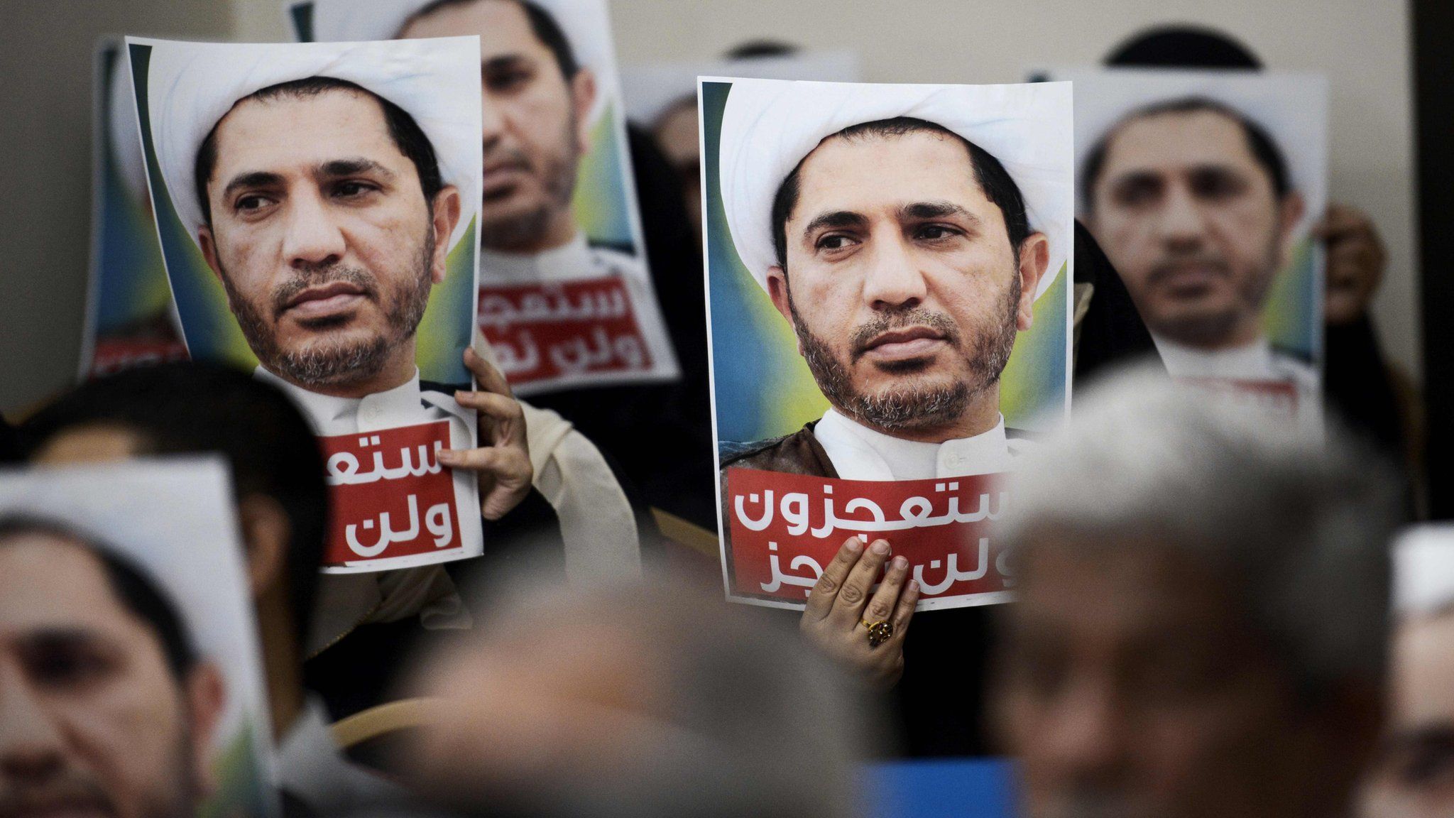 Wefaq supporters hold up posters of Sheikh Ali Salman at a protest in Zinj, Bahrain (29 May 2016)