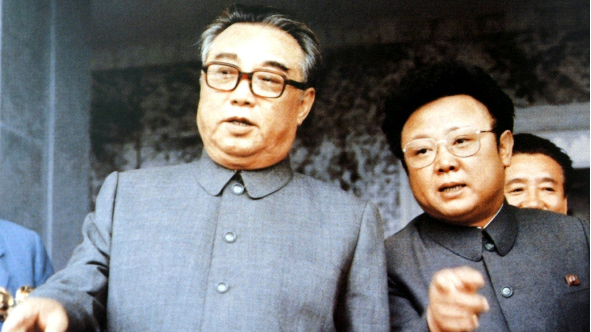 Kim Il-sung, founder of North Korea, chats with his son Kim Jong-il at a mass rally to celebrate the foundation of the country, in September 1983