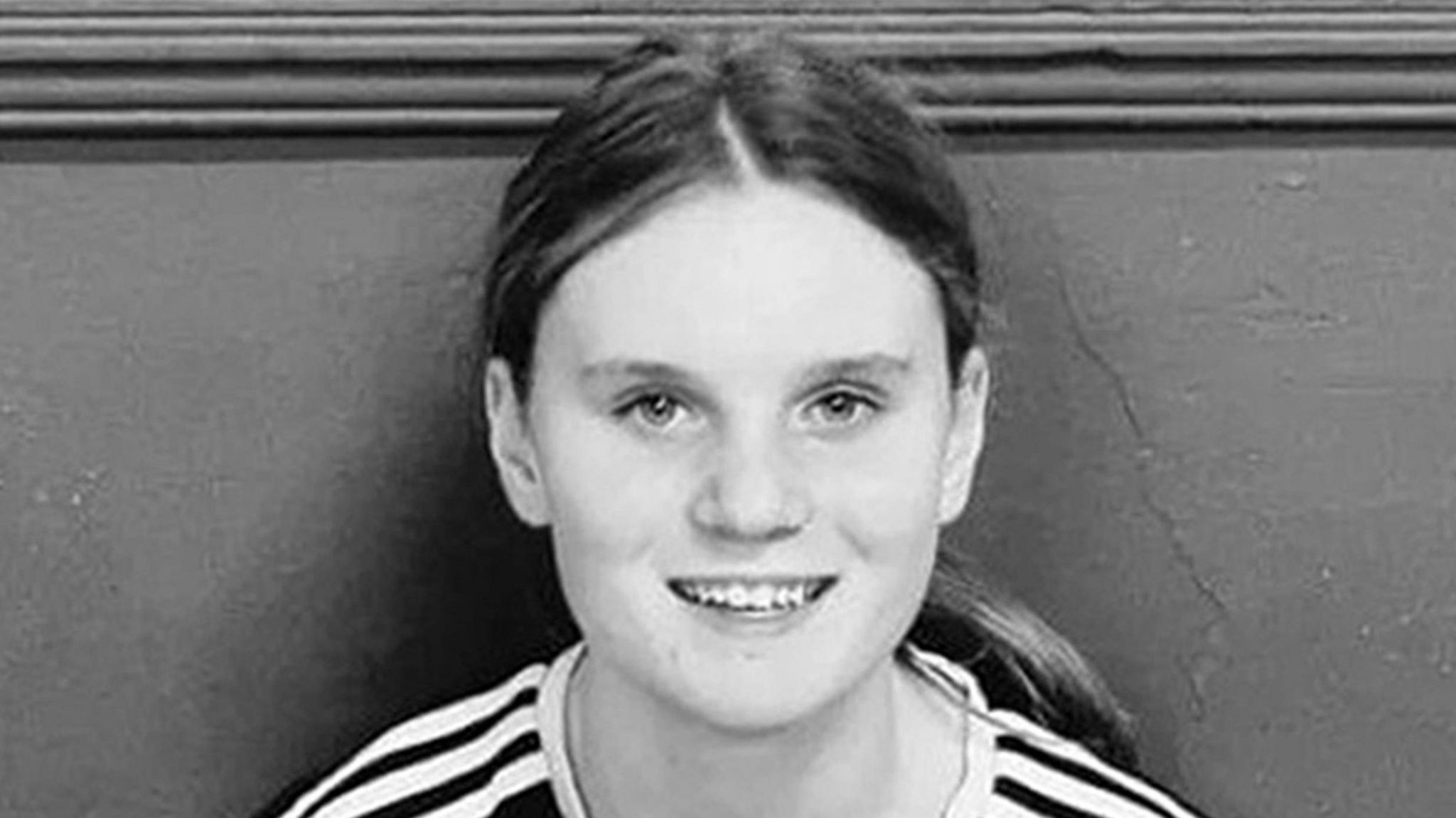 Black and white picture of a teenage girl with long hair in a pony tail