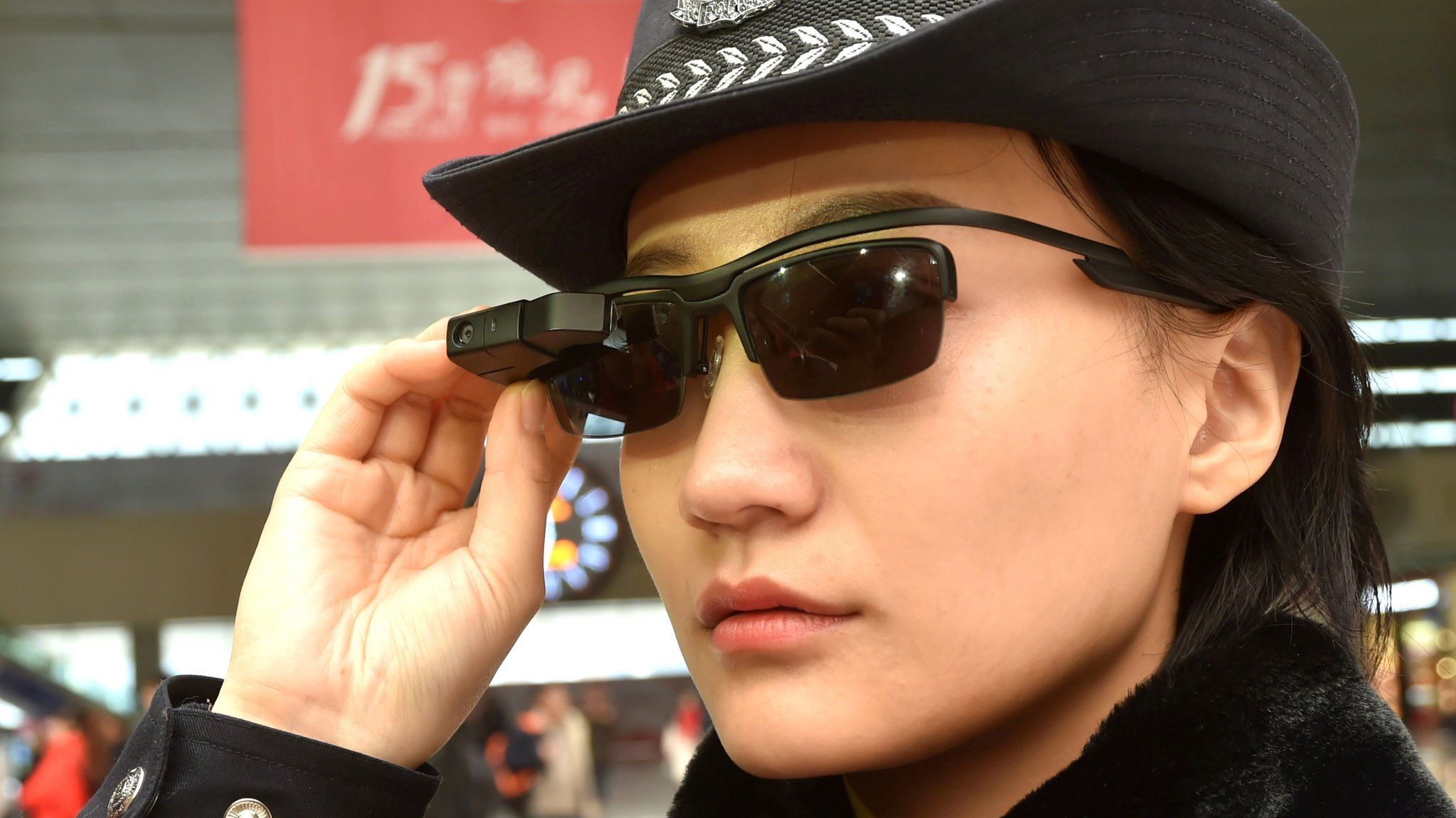 Image shows a police officer wearing a pair of sunglasses with a facial recognition system at Zhengzhou East Railway Station in Zhengzhou in China's central Henan province.