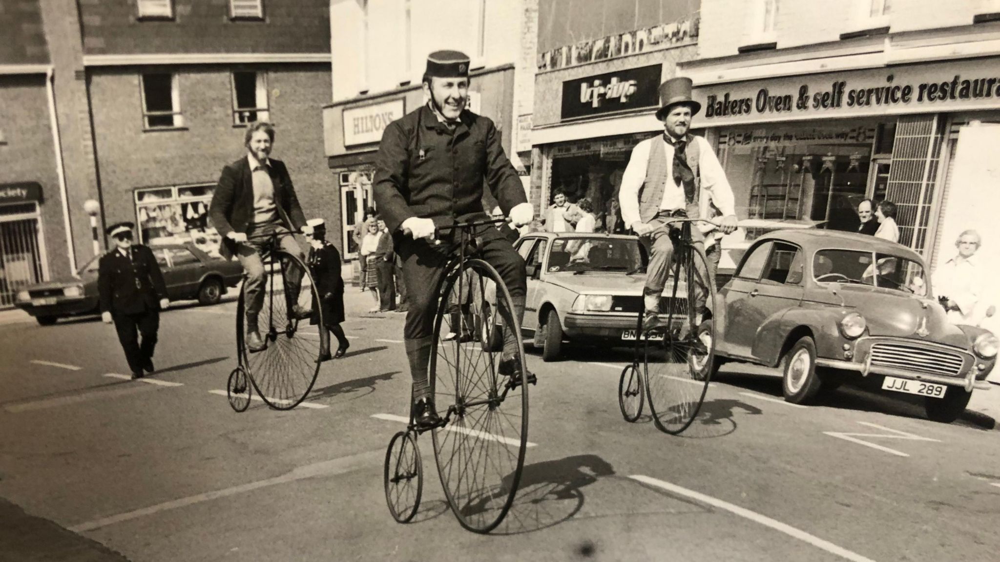 Three men on vintage bikes in March town centre in 1984