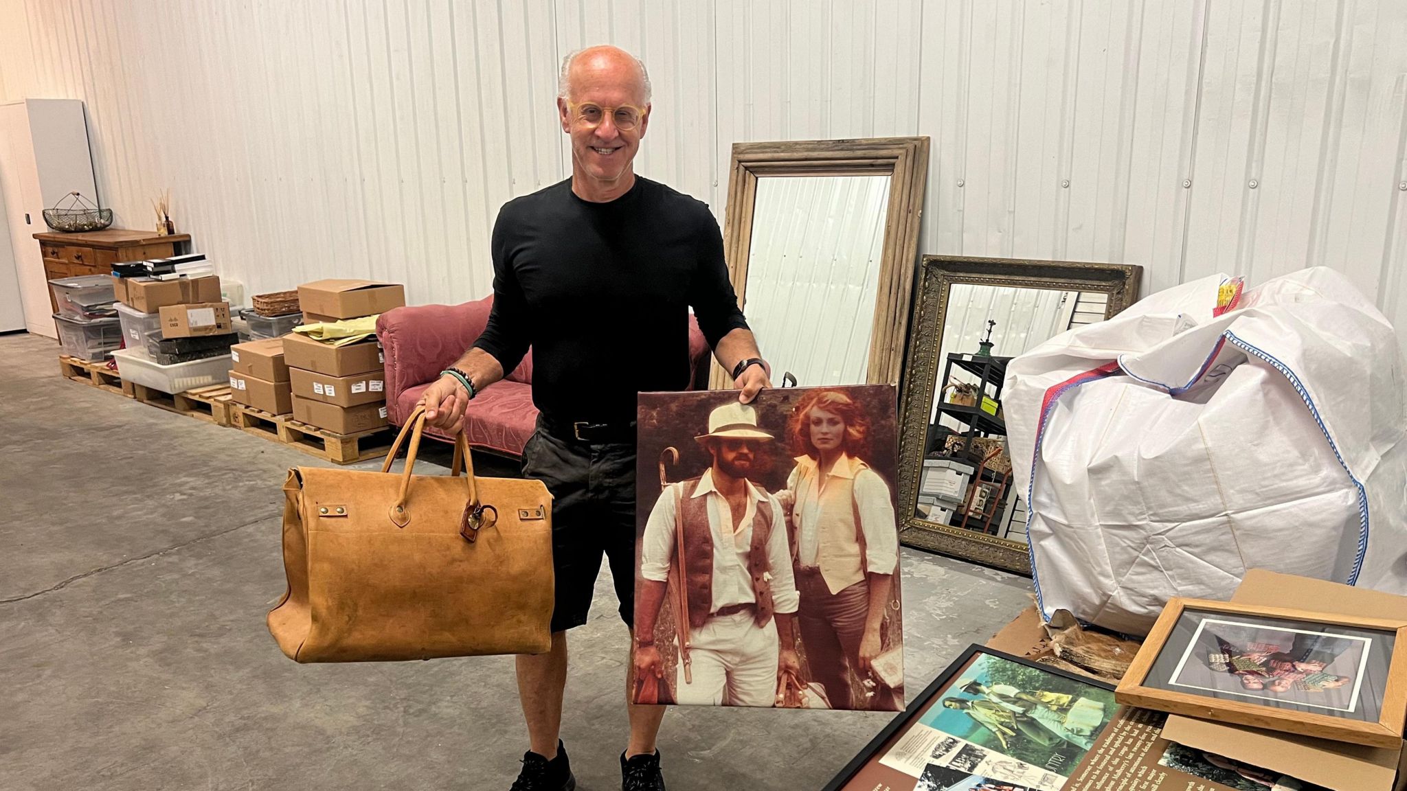 Roger Saul with some of the mulberry collection that is being auctioned off, including a bag