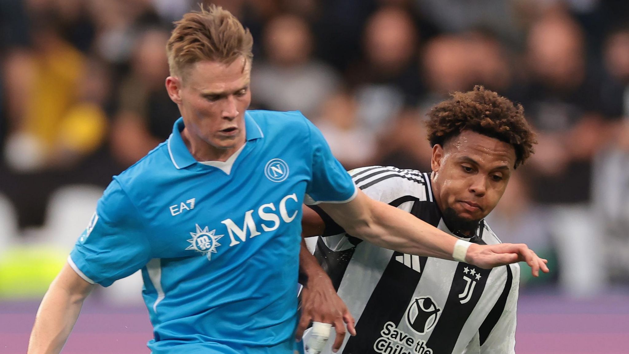 Napoli's Scott McTominay holds off Weston McKennie of Juventus in Turin