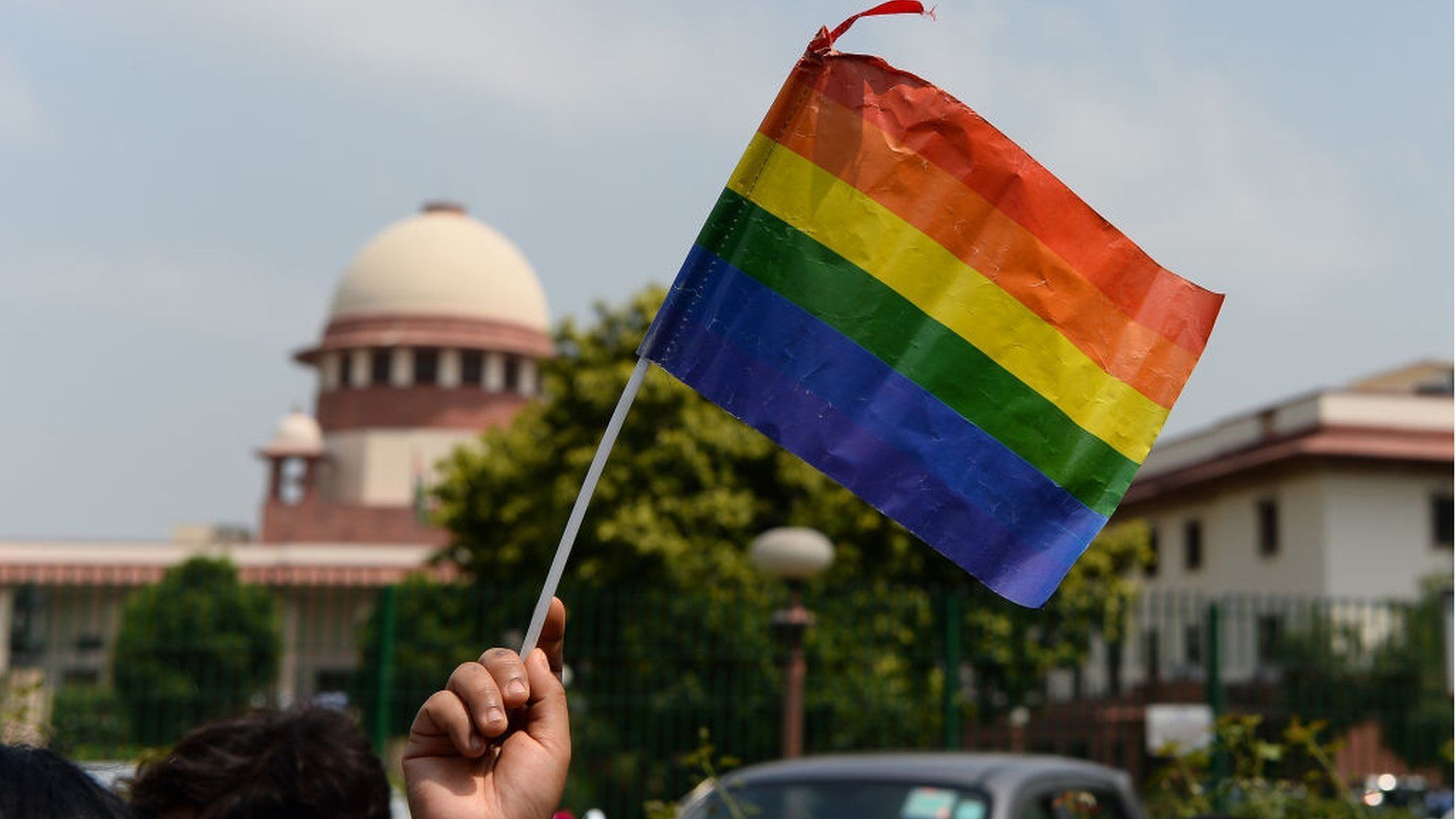 A rainbow flag in front of the Indian Supreme Court