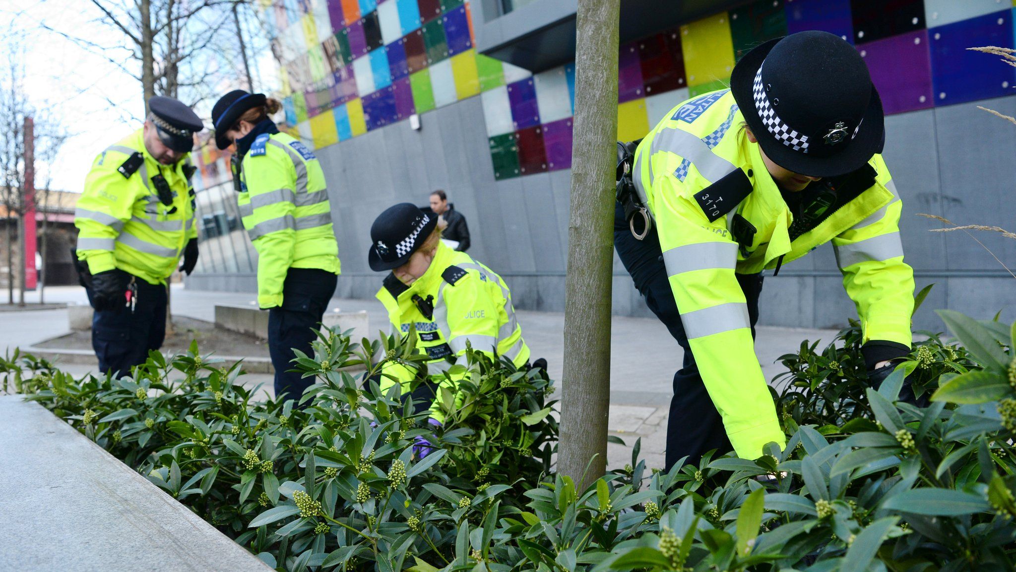 Police officers look for evidence in London