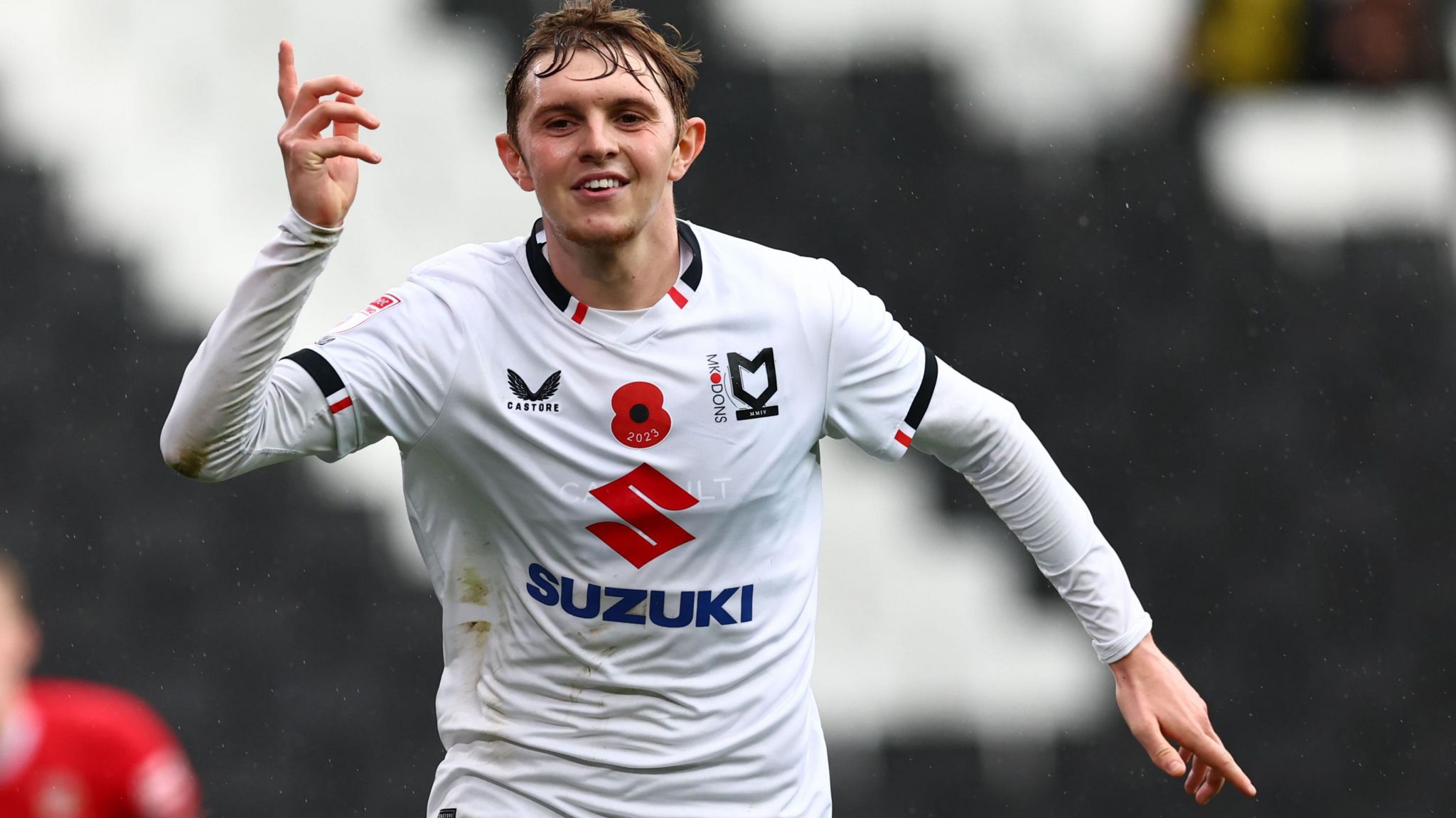 Max Dean on the pitch in MK Dons kit