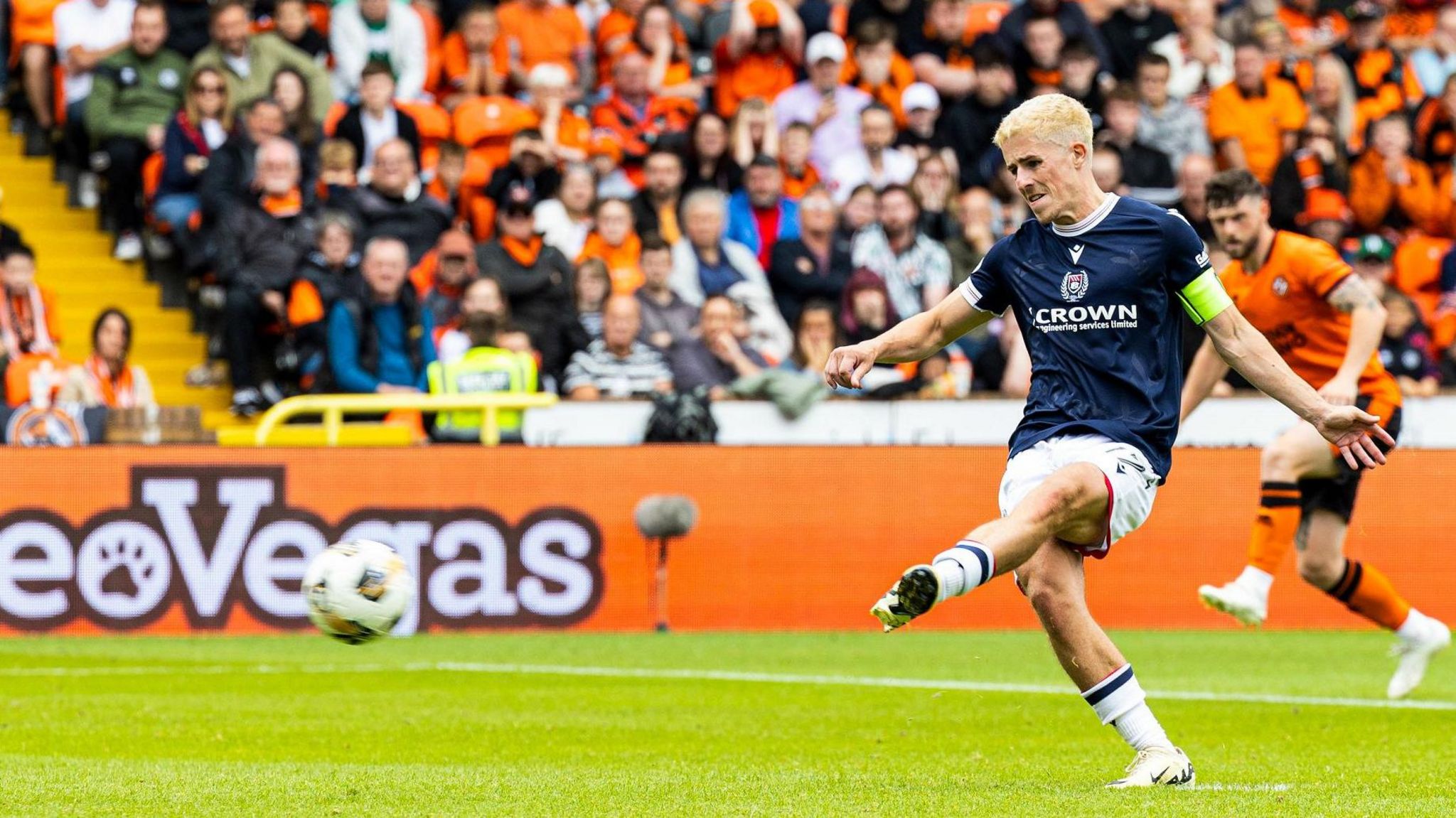 Dundee's Luke McCowan scores from the spot