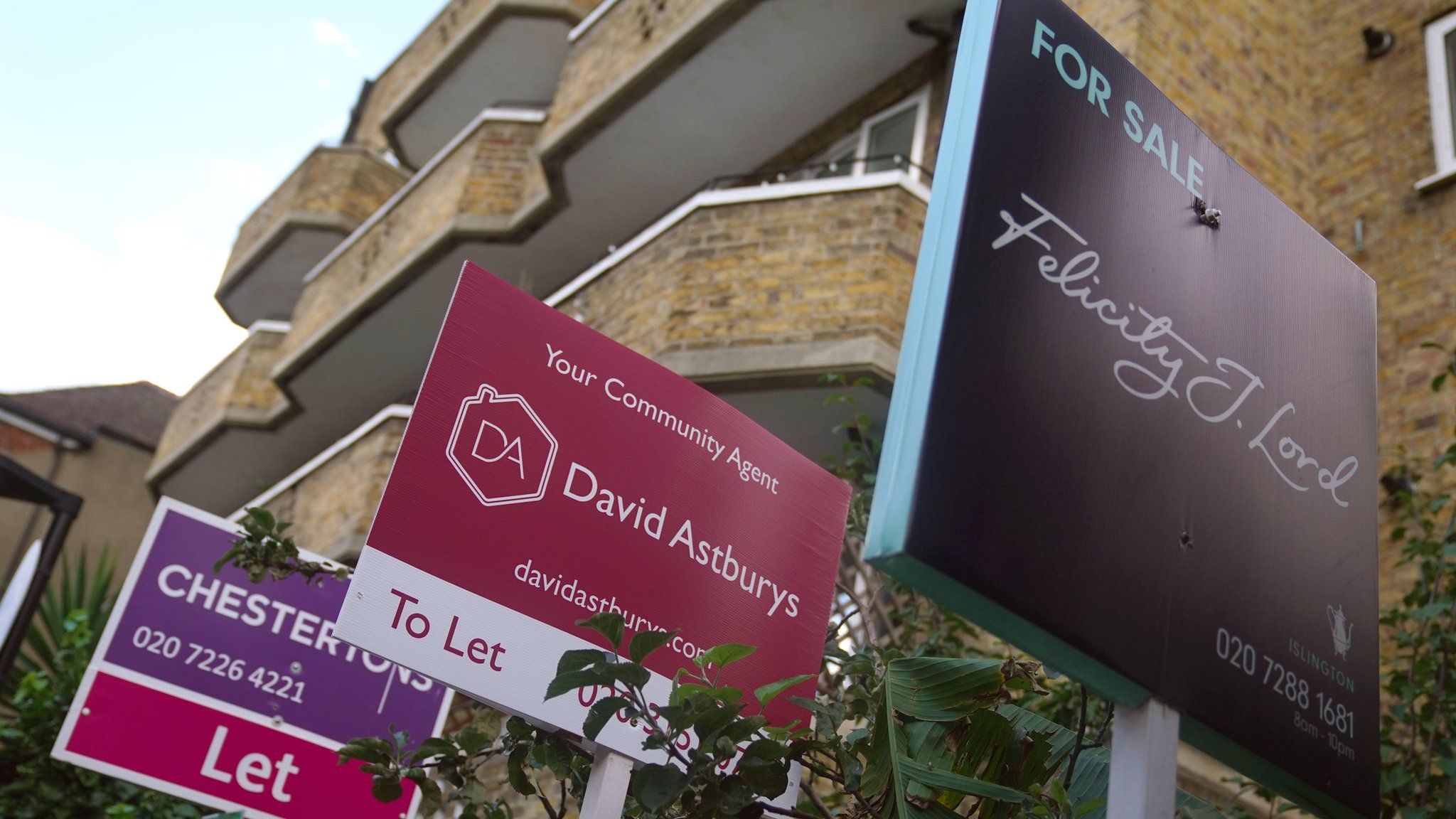 A black of flats with for sale and to let signs outside (file photo)