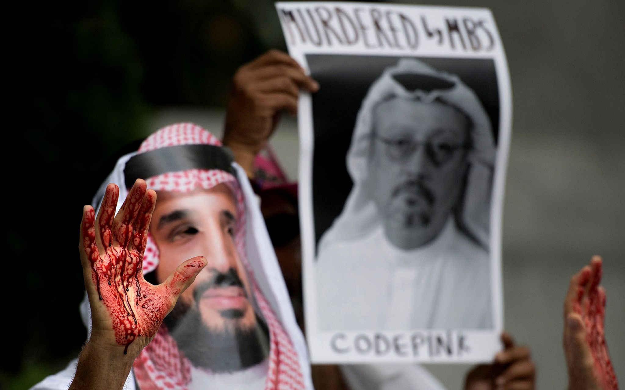 A demonstrator dressed as Saudi Arabian Crown Prince Mohammed bin Salman with blood on his hands protests outside the Saudi Embassy in Washington DC, October 2018