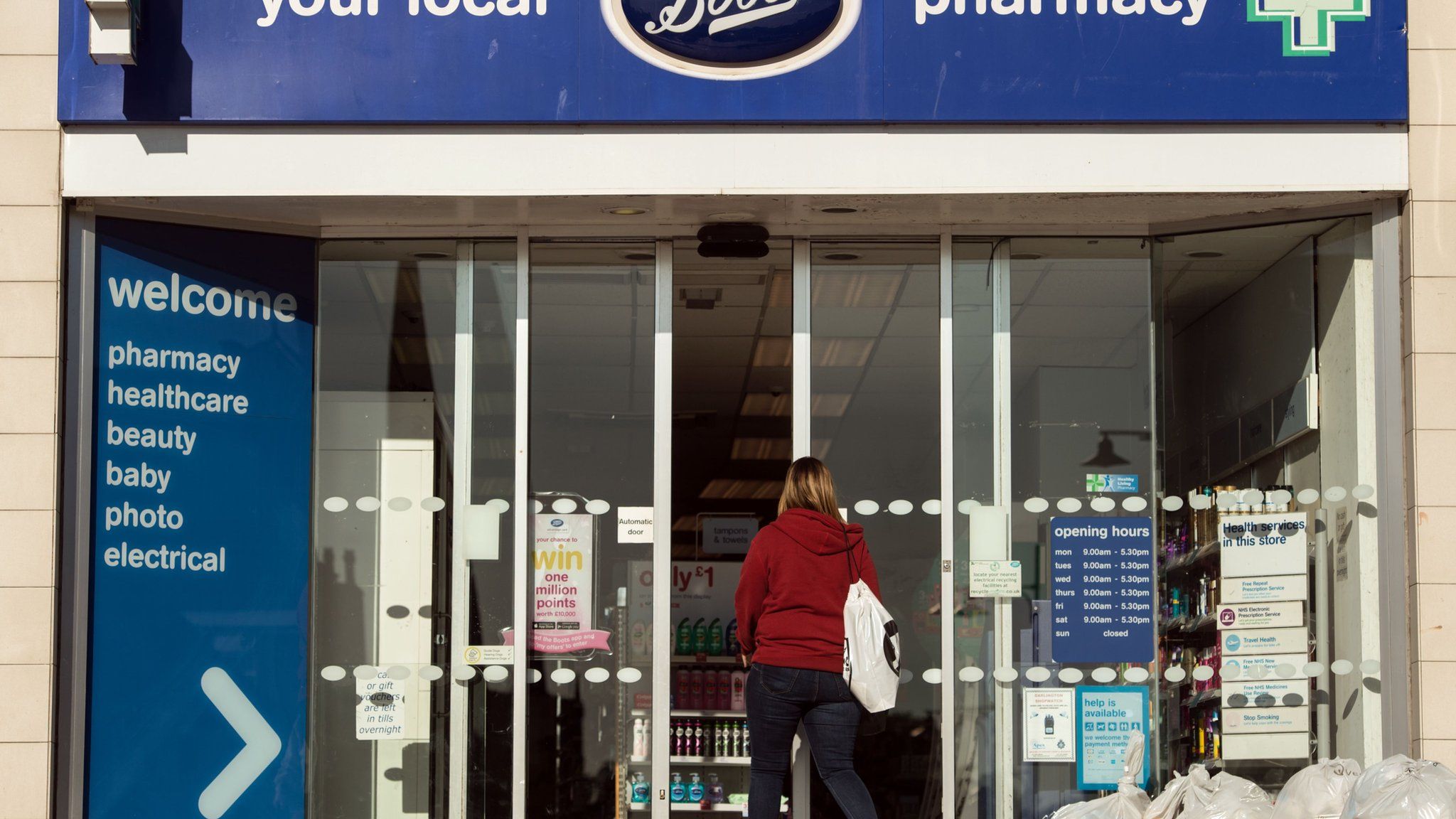A sign is pictured above the entrance to a branch of Boots pharmacy in the town centre of Darlington, northern England on September 6, 2018