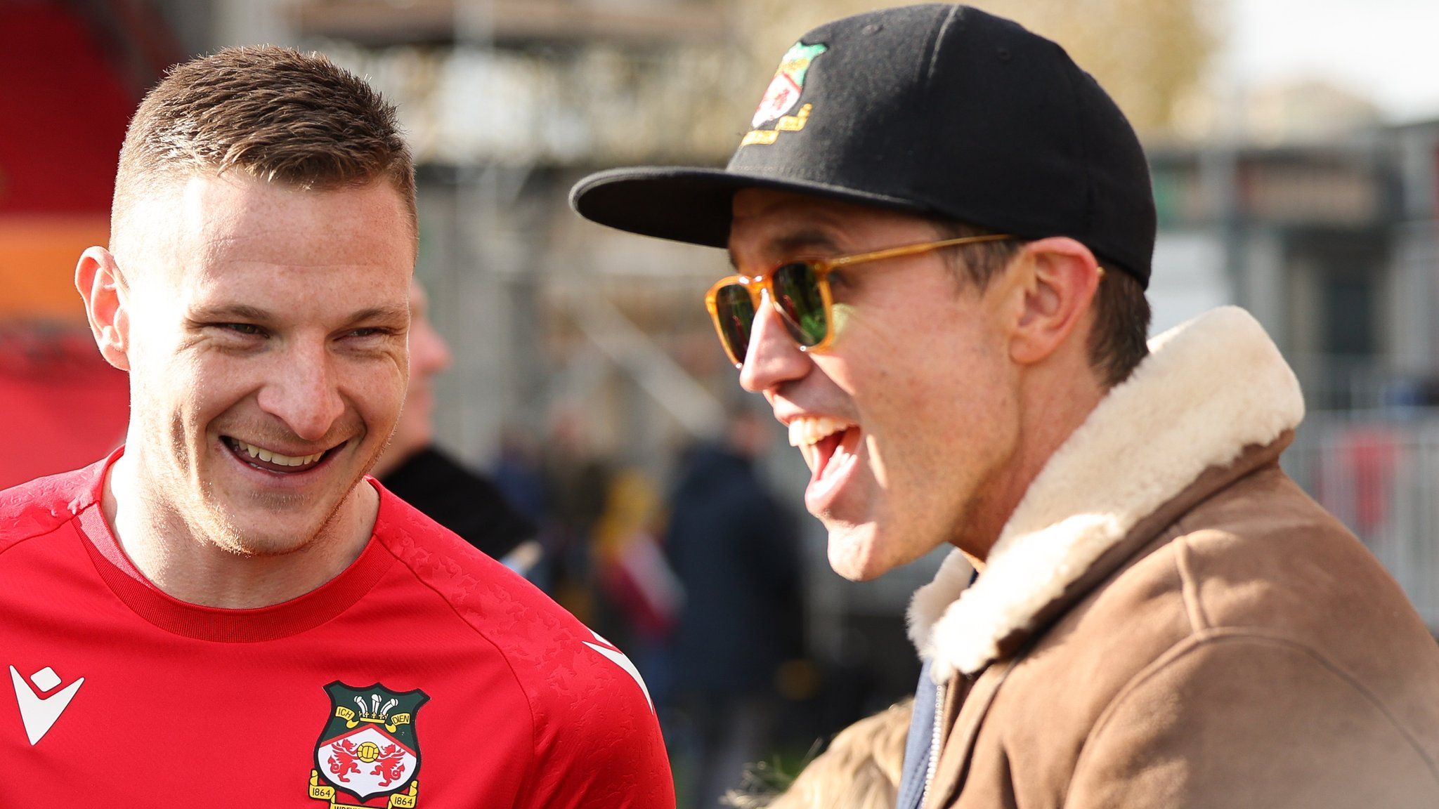 Wrexham striker Paul Mullin chats to American actor and co-owner of Wrexham Football Club, Rob McElhenney after their win against Notts County