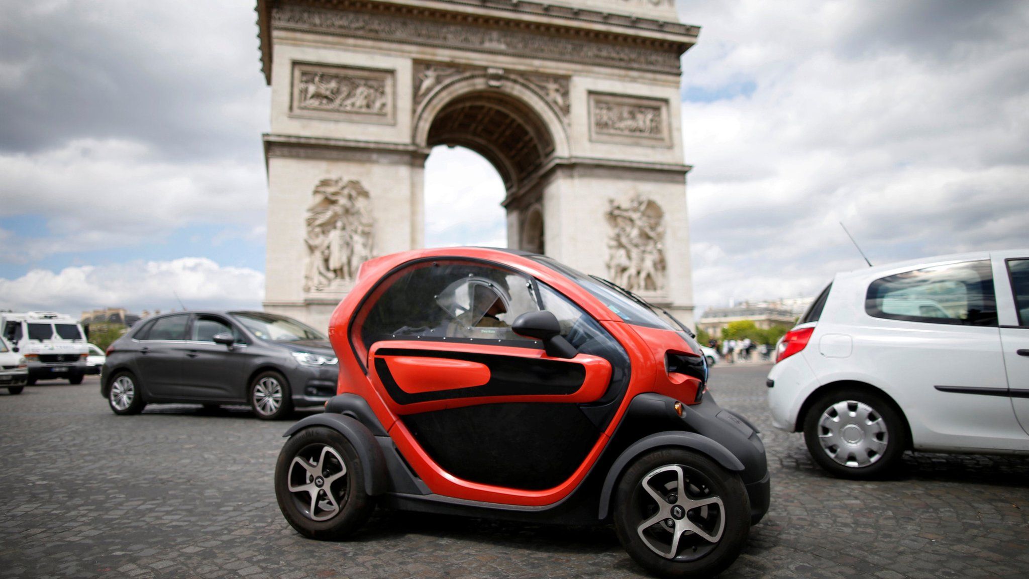 An electric car from Renault, drives past the Arc de Triomphe in Paris on 30 May 2017