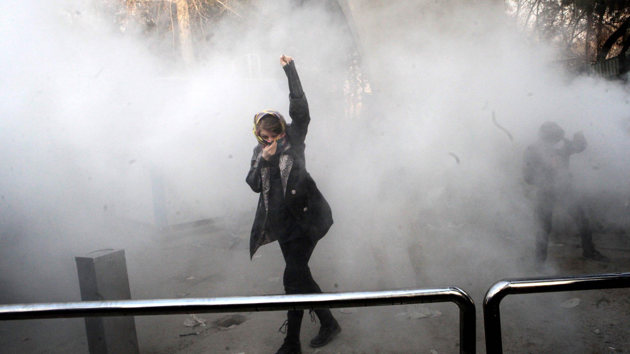 An Iranian woman raises her fist during a protest in Tehran on 30 December 2017