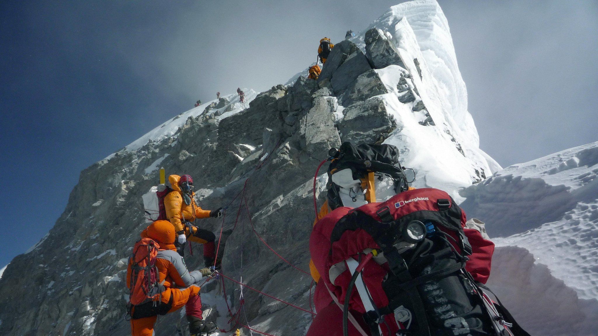 Unidentified mountaineers walk past the Hillary Step while pushing for the summit of Everest on May 19, 2009,