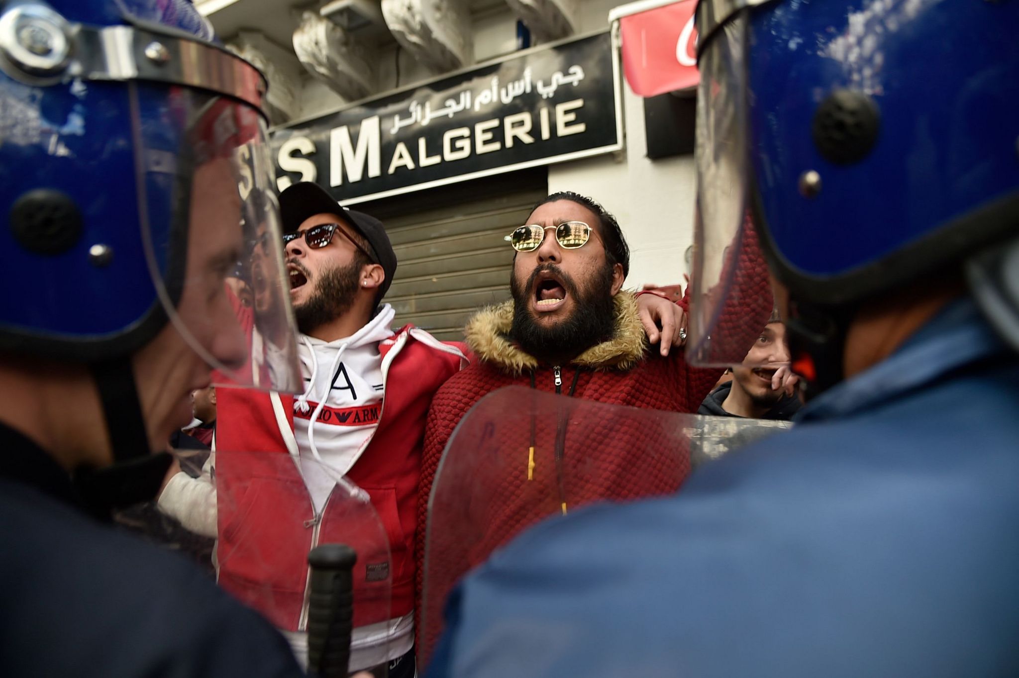 Members of the security forces stand guard as Algerian students protest on the main campus of the University of Algiers against the fifth term of Abdelaziz Bouteflika