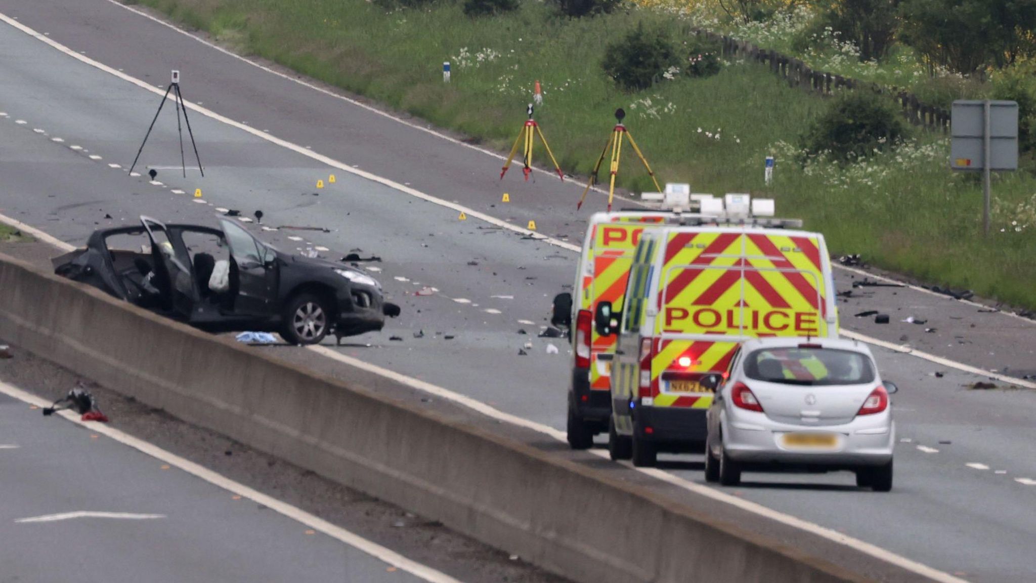 The wreckage of a car with signs of forensic investigation