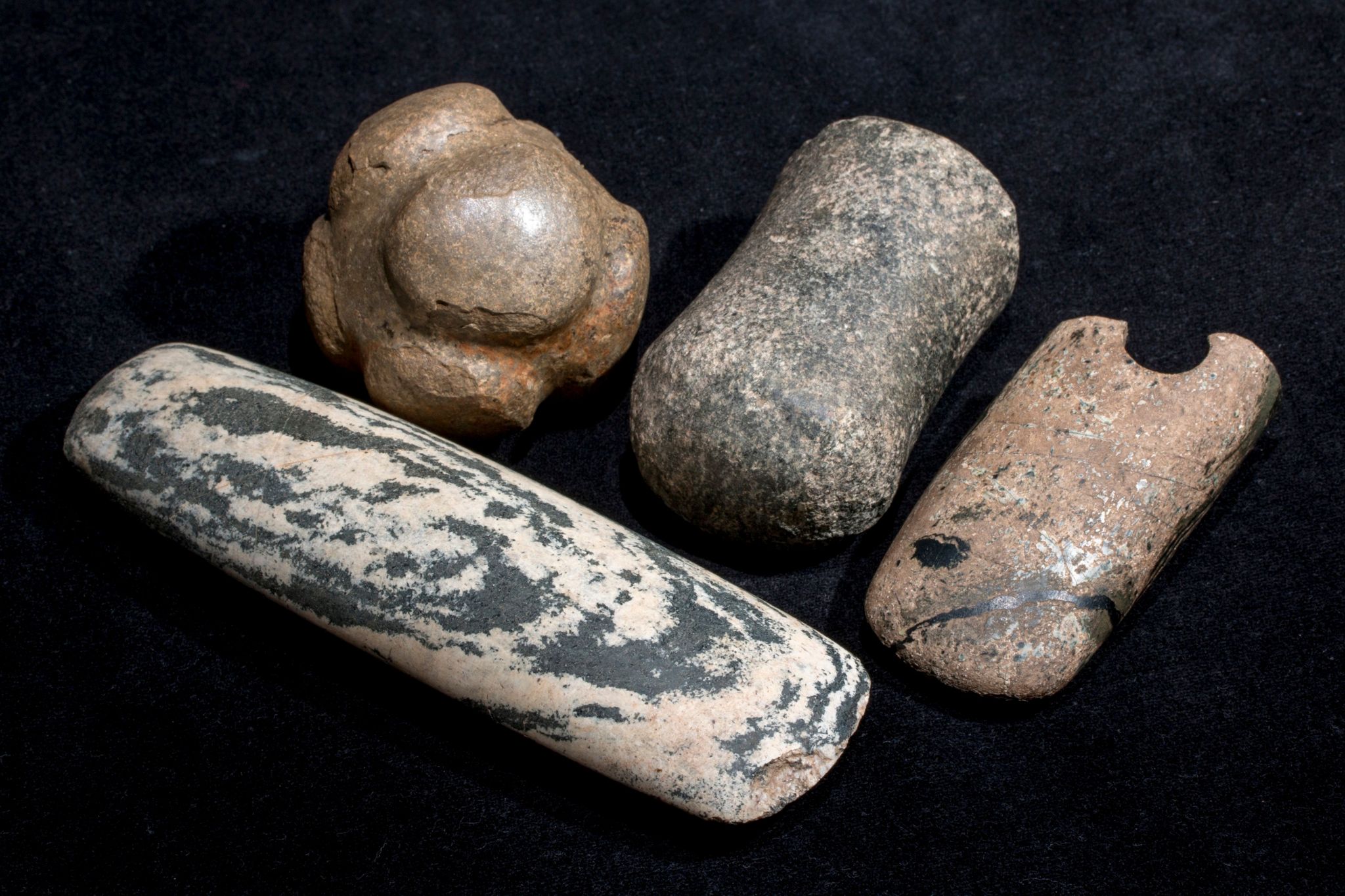 Polished stone artifacts including a stone ball, axehead and maceheads