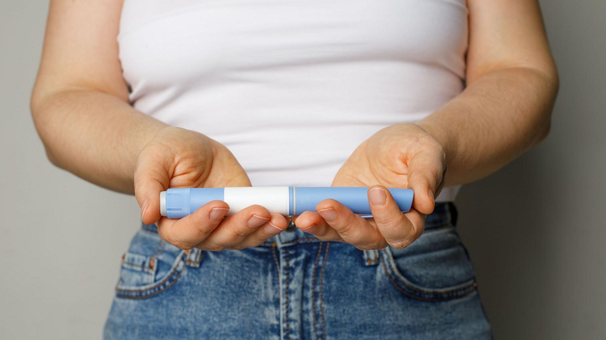 Woman holding a weight-loss jab