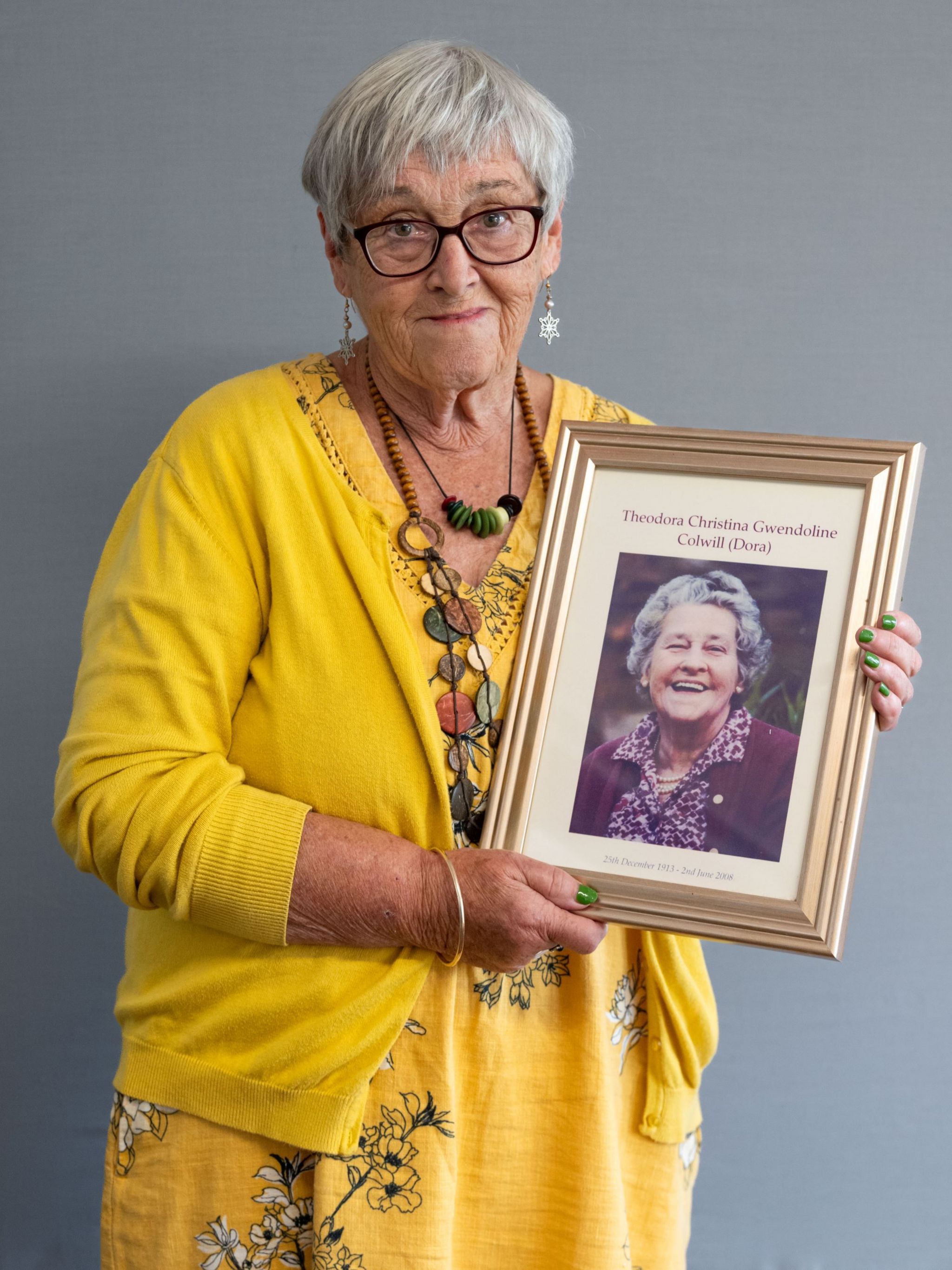 Rosalie Dunn holds a portrait in a frame