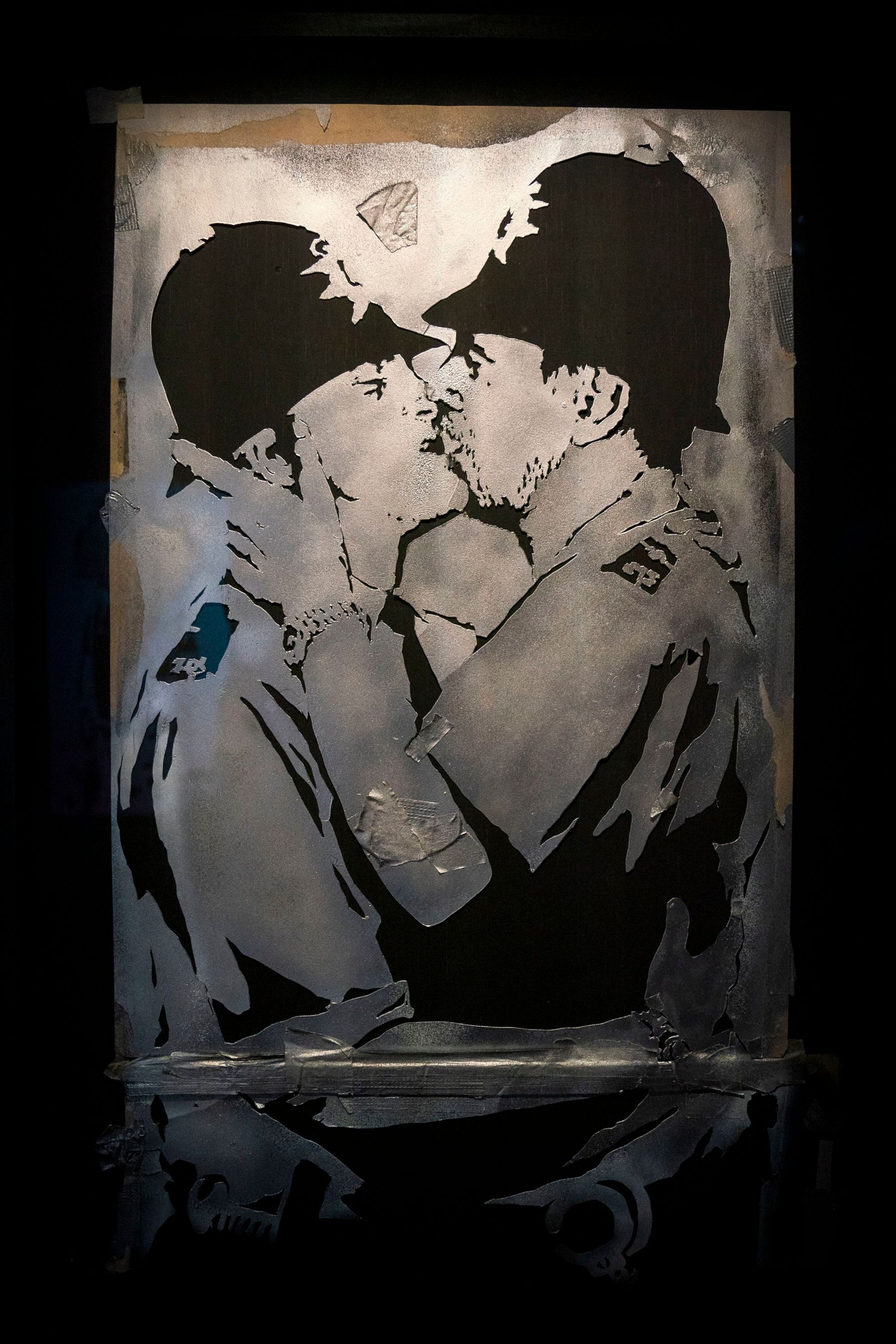 tencil featuring kissing policemen in the new show by artist Banksy 'Cut & Run' which opens this Sunday at Glasgow's GoMA