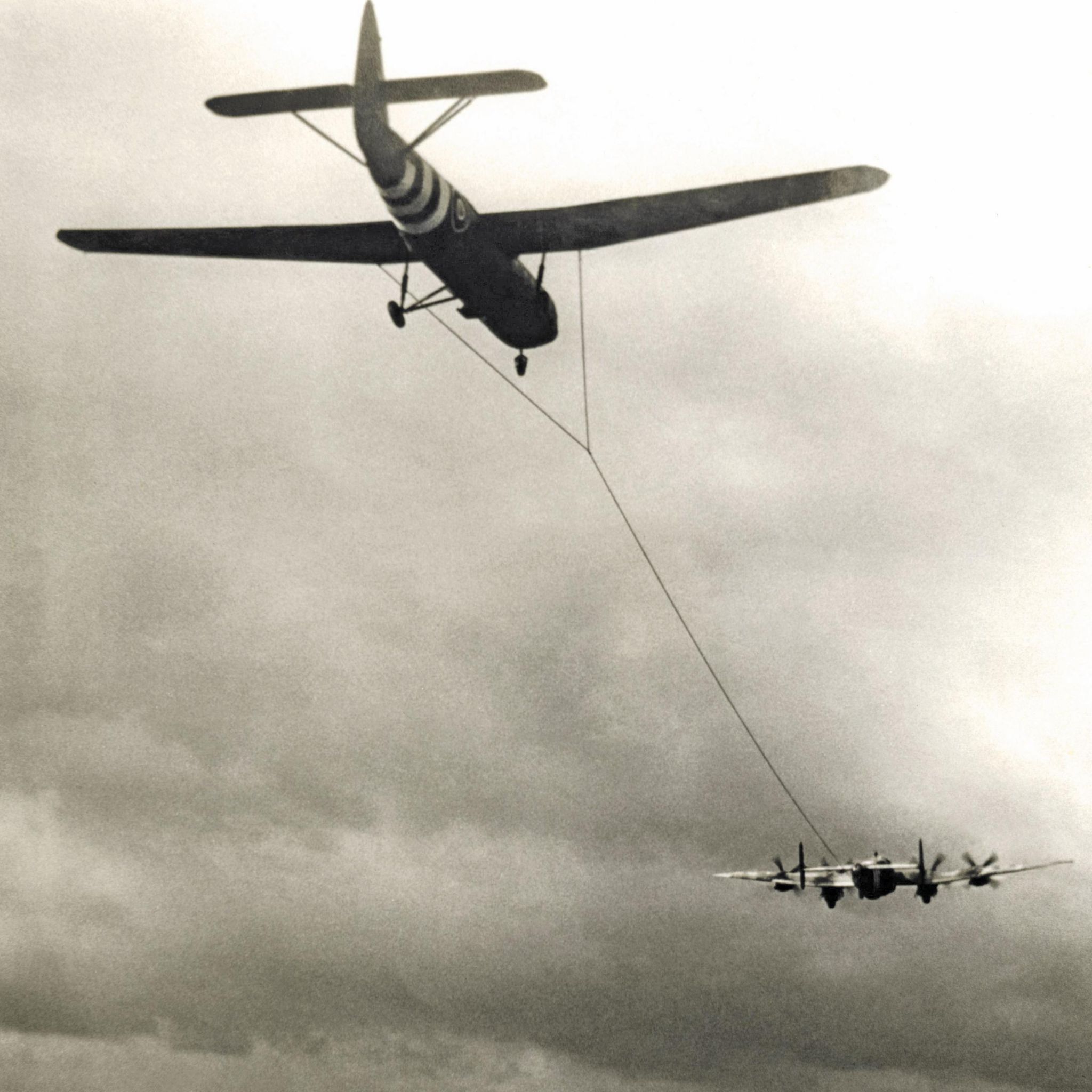 A World War Two glider being towed by a bomber