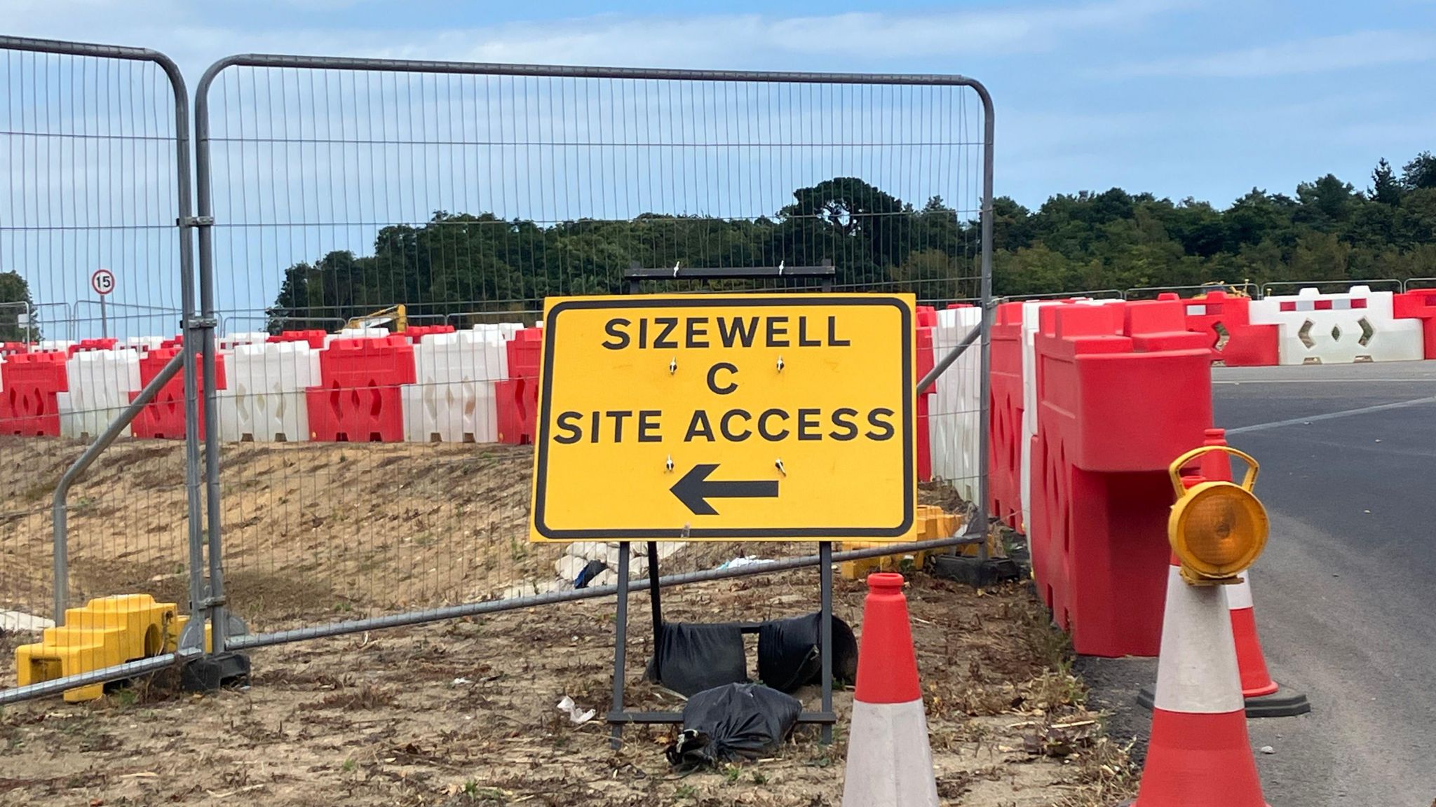 A yellow sign saying "Sizewell C Site Access" and including an arrow symbol