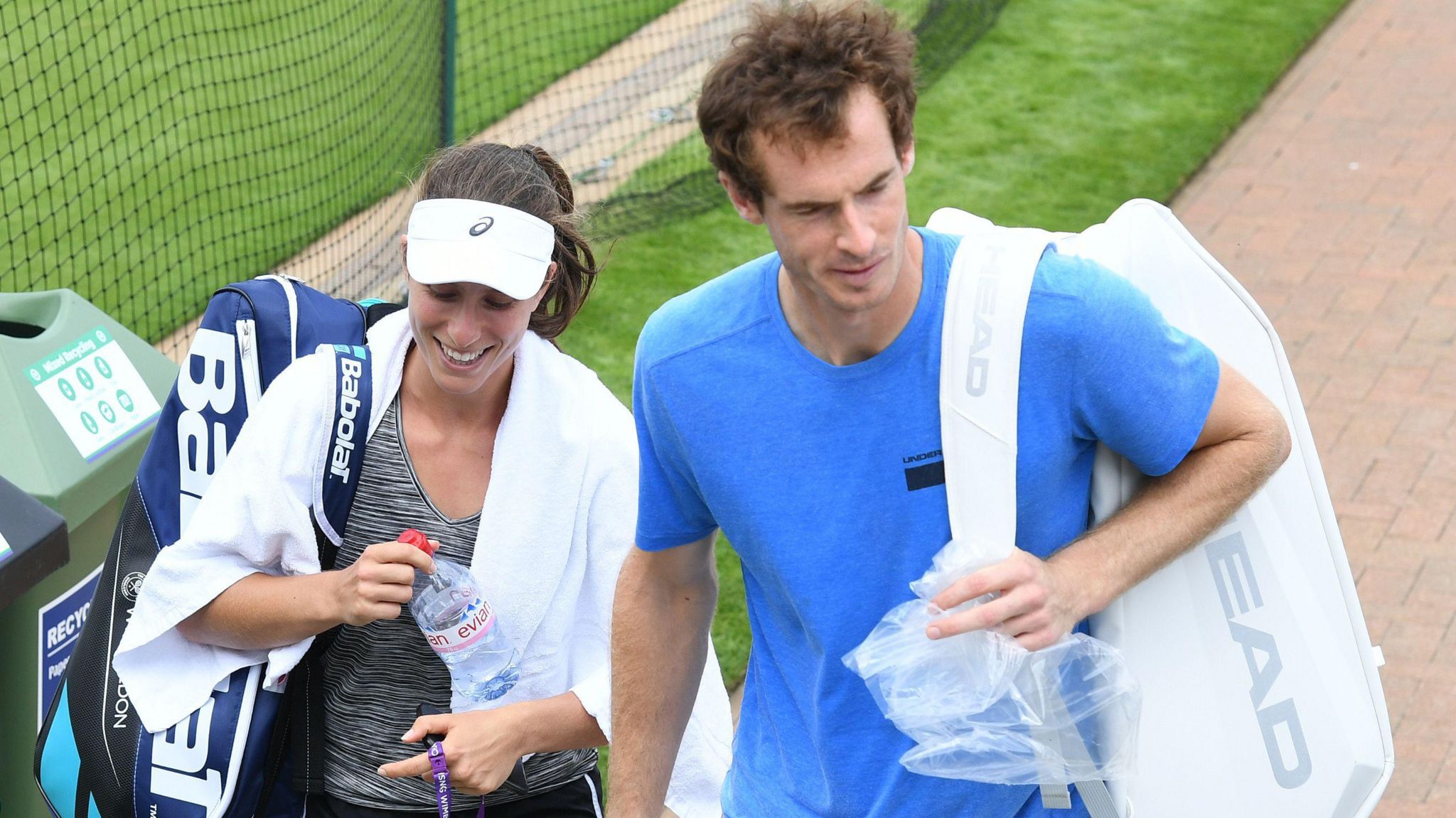 Johanna Konta, left, with Andy Murray walking past the training courts at Wimbledon